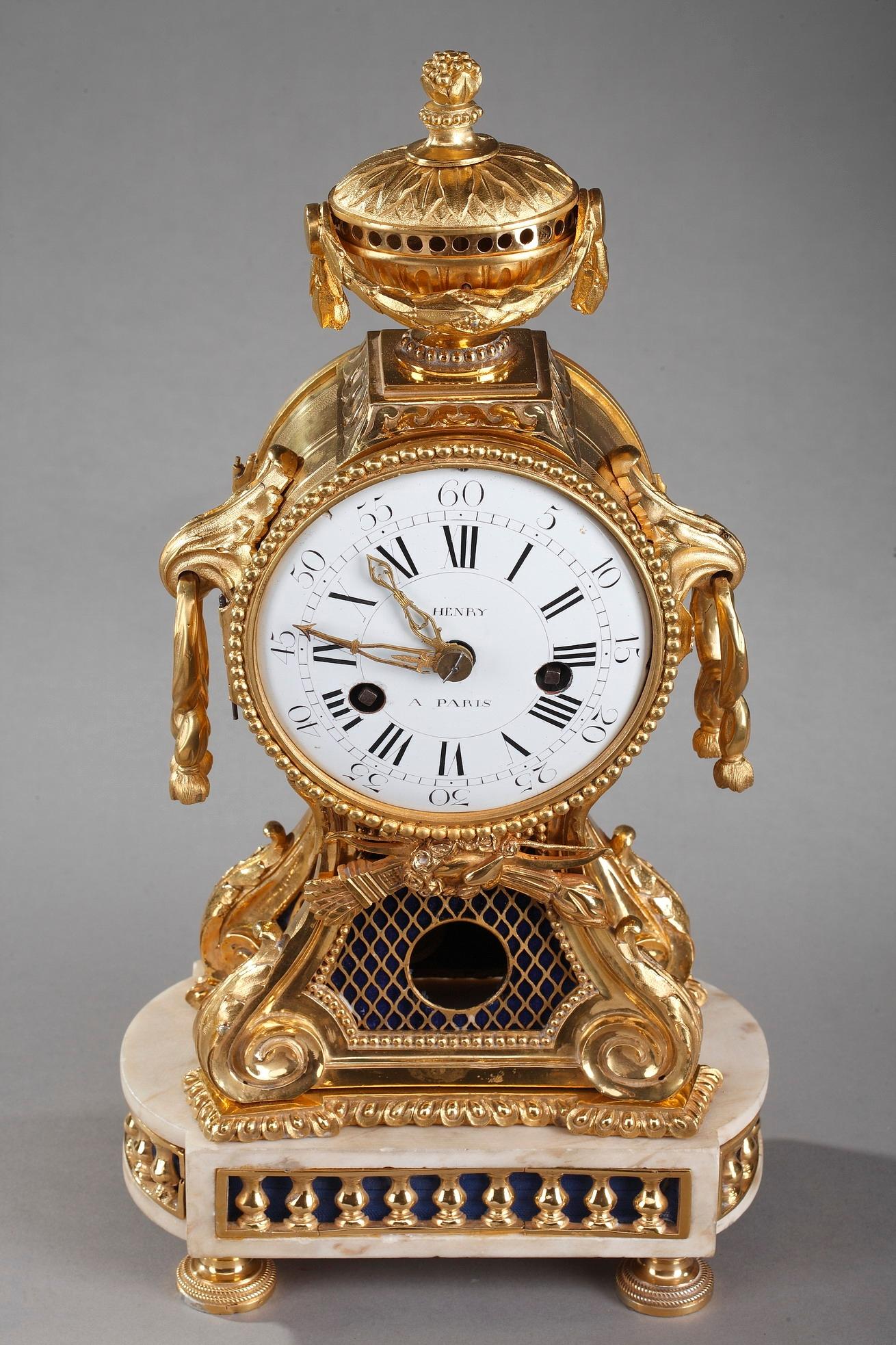 Louis XV-Louis XVI period ormolu and white marble pendulum clock by the clockmaker Henry in Paris. The enamel dial signed HENRY A PARIS is topped by a vase and supported by four foliated consoles. It marks the hours with Roman numerals and the