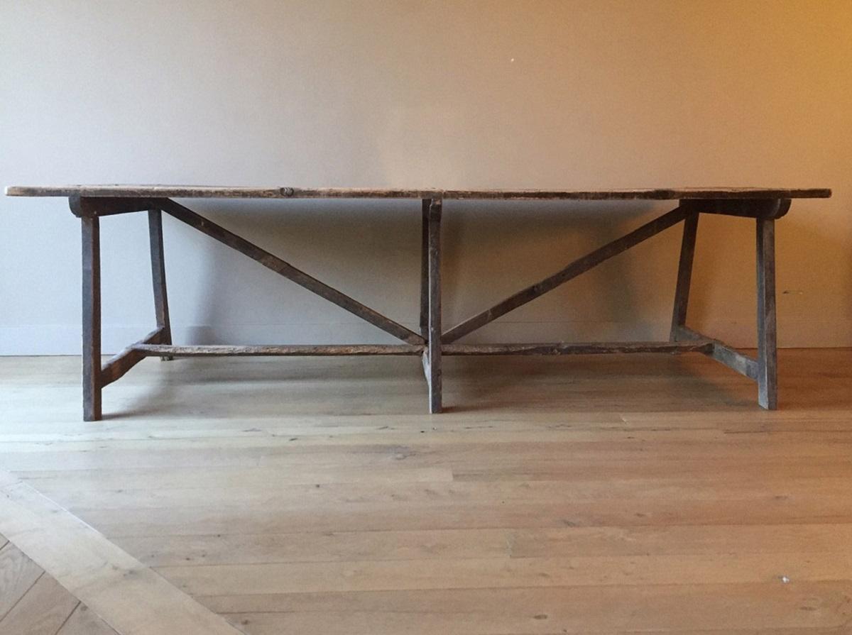 Great 18th century mountain trestle table from the Pyrinees region (border Spain and France). It is made from mountain pine with remnants of the original black varnish which has aged and craqueled beautifully. All original with lovely proportions