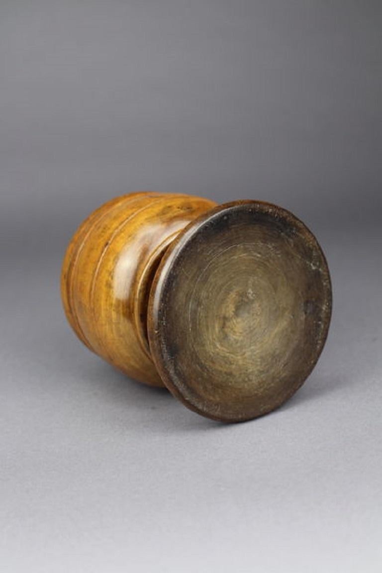 A Pole-Lathe turned pearwood storage jar and cover, probably early 18th century. The cover and body with banded and reeded ornament, on a waisted stem and stepped circular foot. A comparable example was sold by Christie's in the Jonathan Levi 'Treen