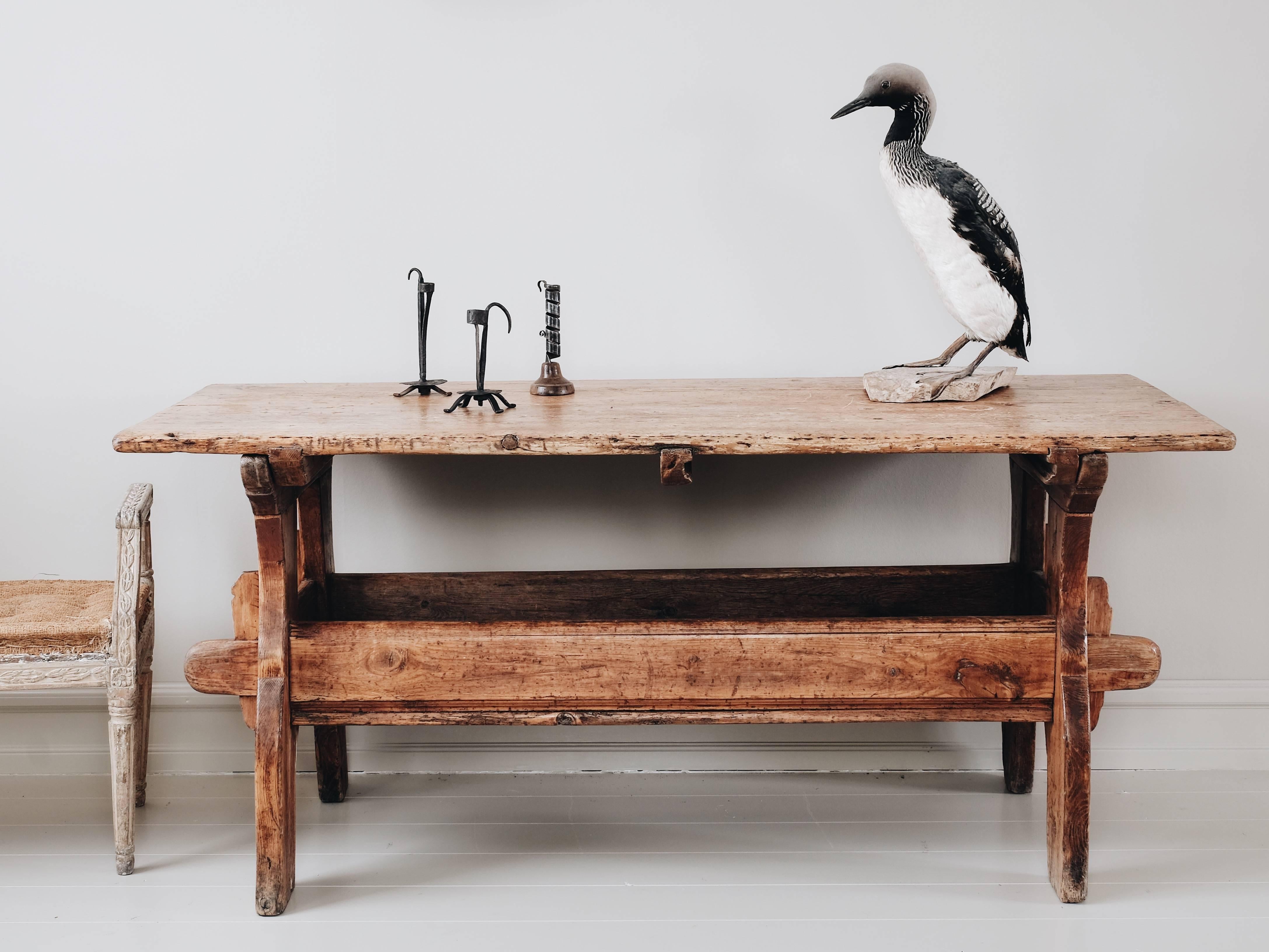 A good 18th-century Swedish Folk Art trestle table in its original finish with great patina and storage in the stretcher, circa 1800.