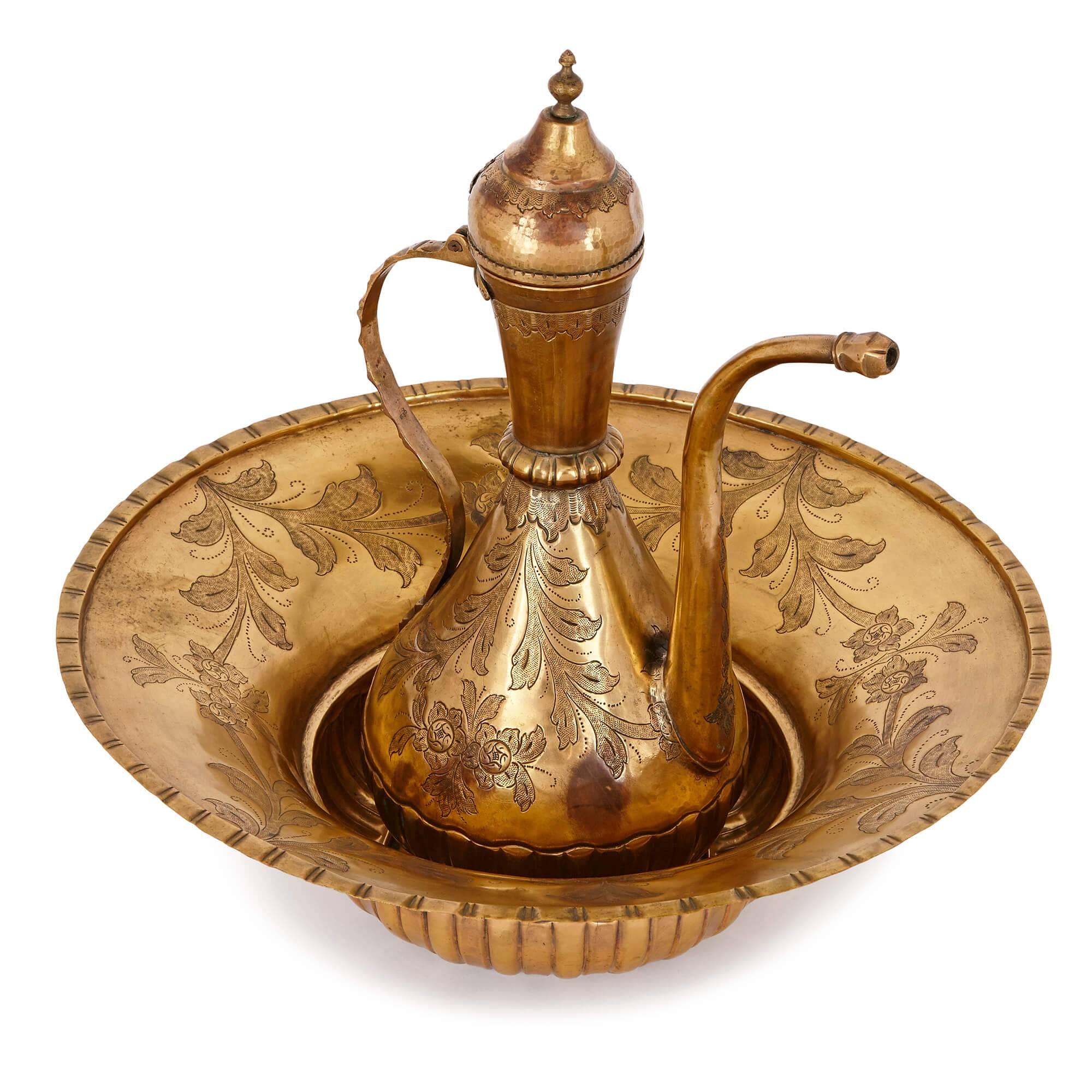 This beautiful ewer and basin set is a delightful product of the 18th century Ottoman Empire, with a striking design aesthetic. It is made from 'tombak', or gilt-copper, a material commonly used in the Ottoman Empire to make precious and ceremonial