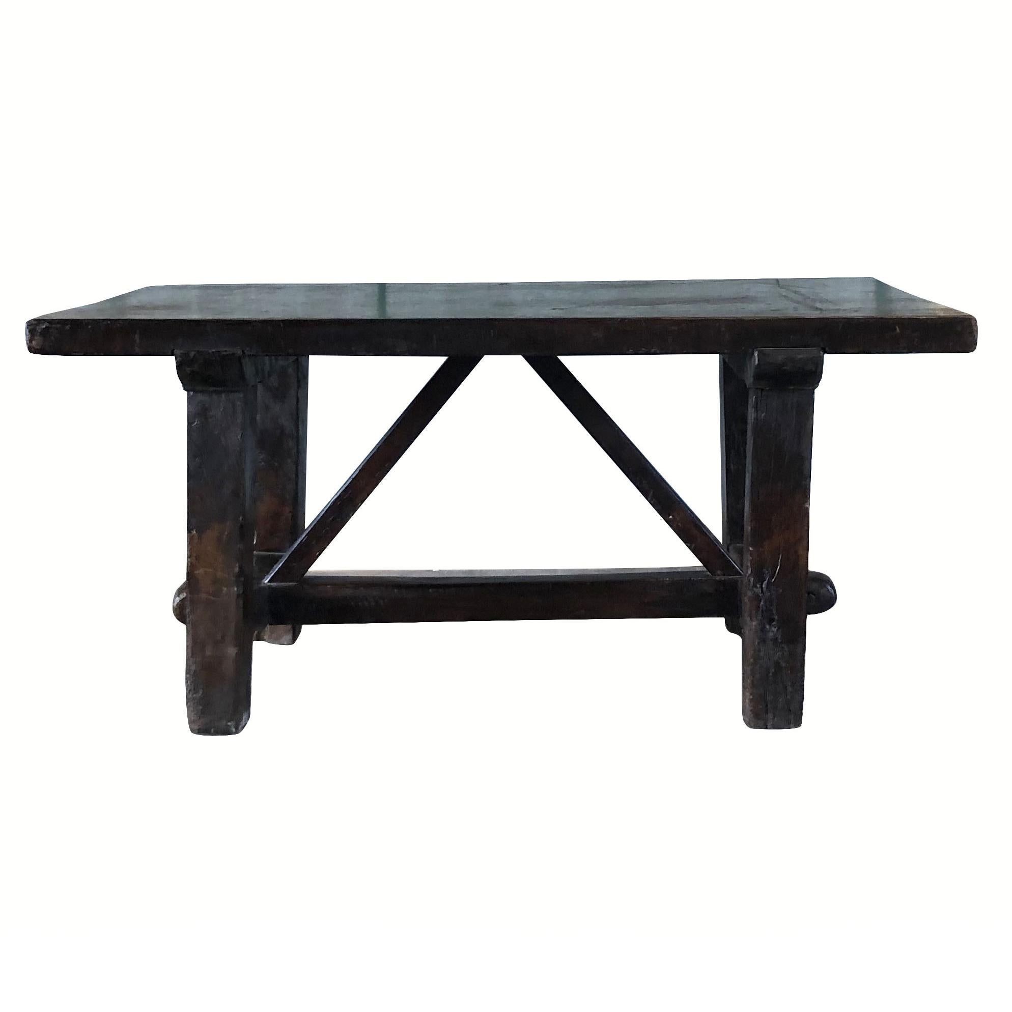 An antique Tuscan kitchen work table made of dark waxed walnut, enhanced by detailed wood cavings. The hand carved farm table is in good condition. Wear consistent with age and use. Circa 1760, Tuscany, Italy.