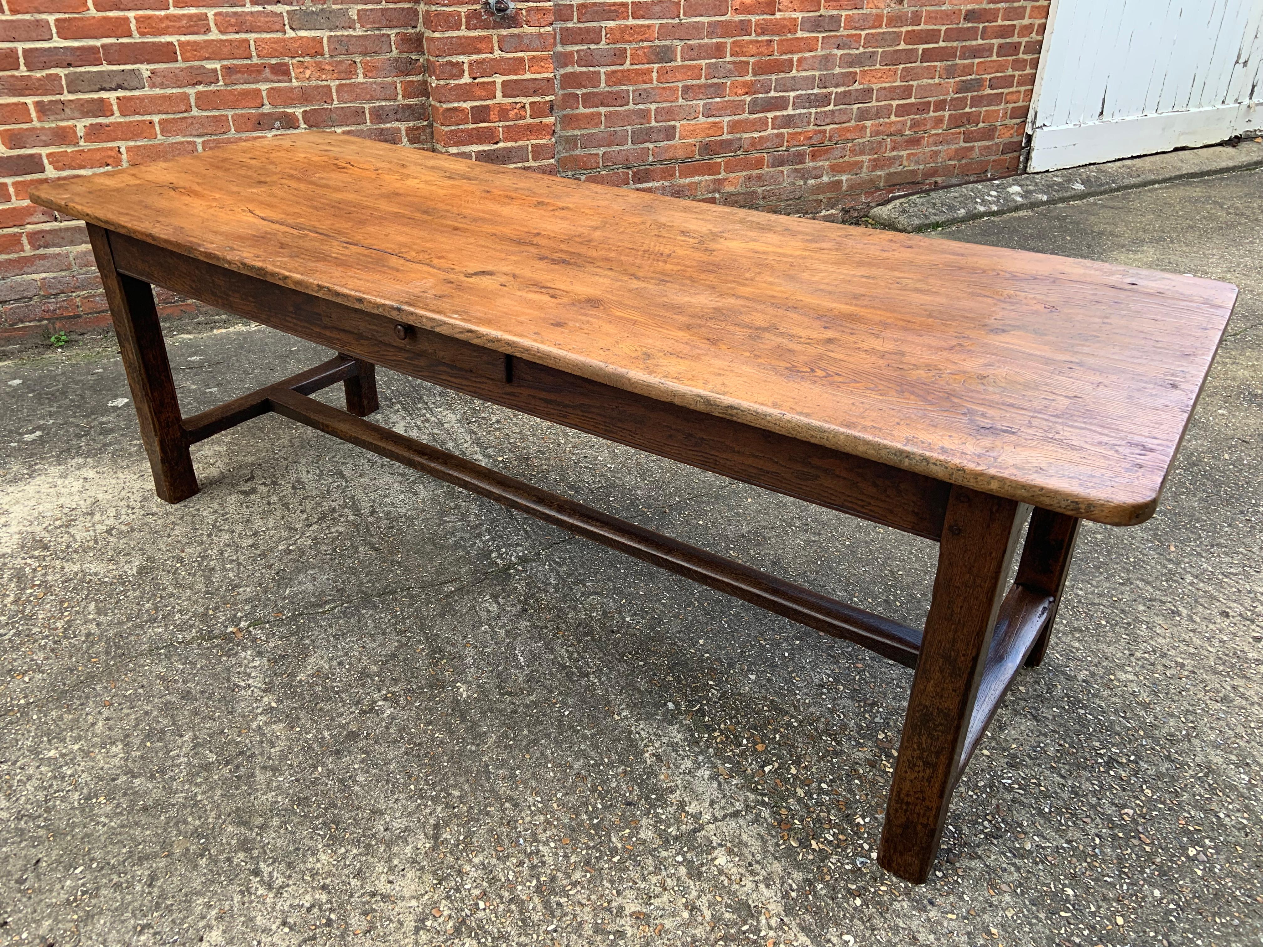 18th Century two plank elm farmhouse table with oak base. Beautiful original colour and patination. The patina to the top from years of use is stunning and gives the piece a superb look that would fit well in a number of interiors. The base has an H