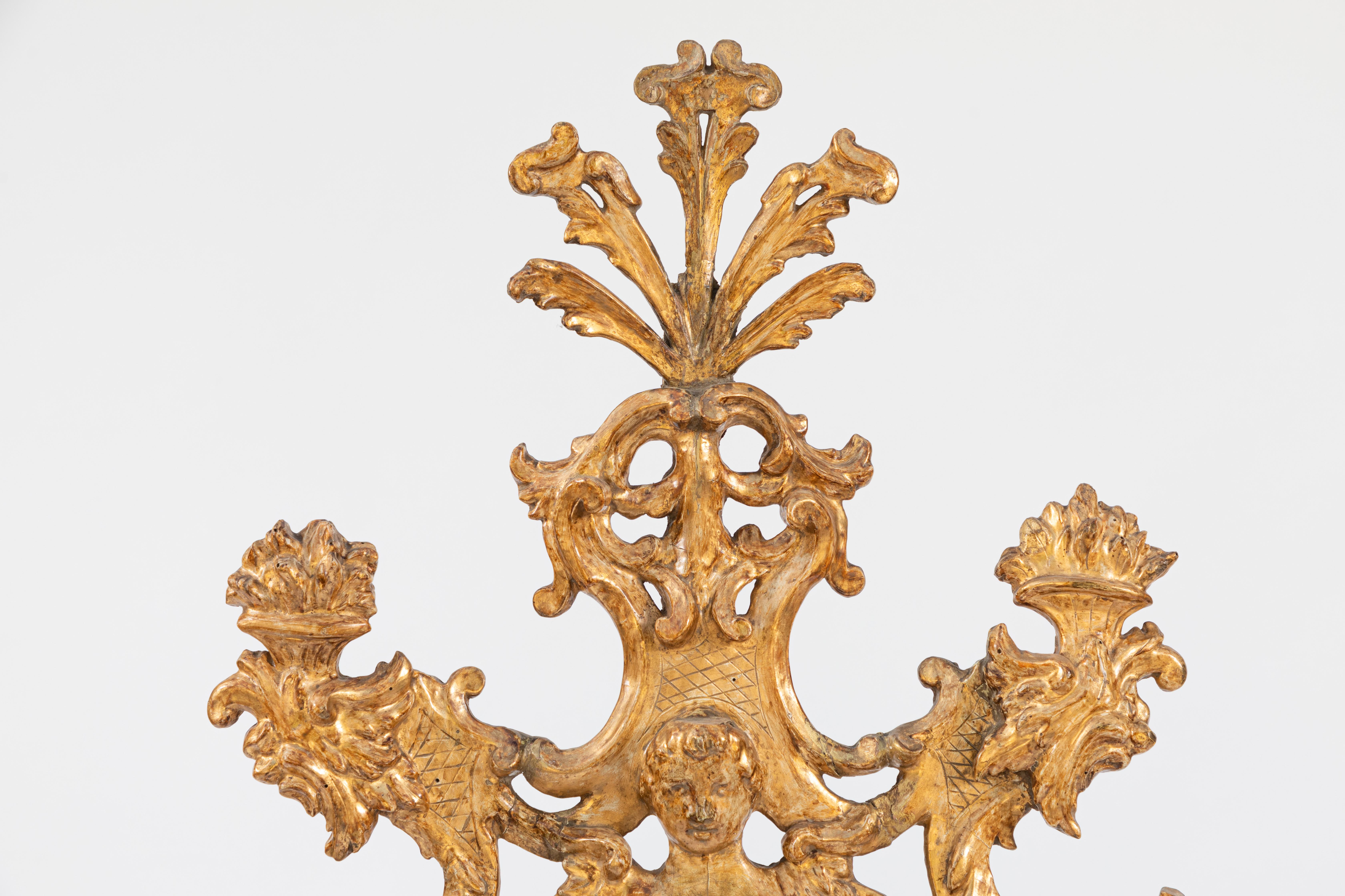Very fine 18th century Venetian carved giltwood mirror with cherub and flower basket motif.
