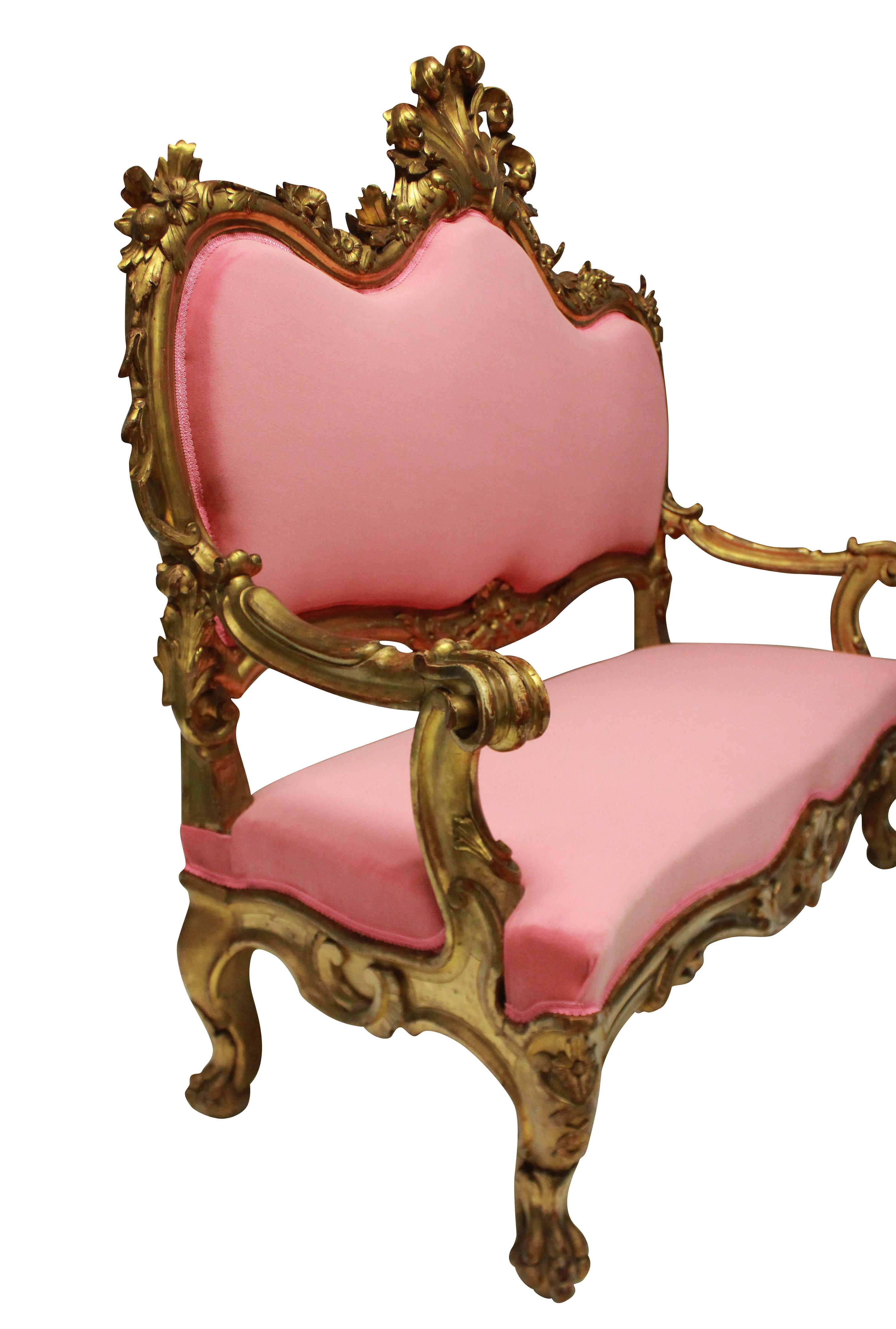 A fine 18th century Venetian carved giltwood settee, with shell crest and lion mask and paw feet, amongst boldly carved and water gilded foliage. Newly upholstered in bubblegum pink velvet.