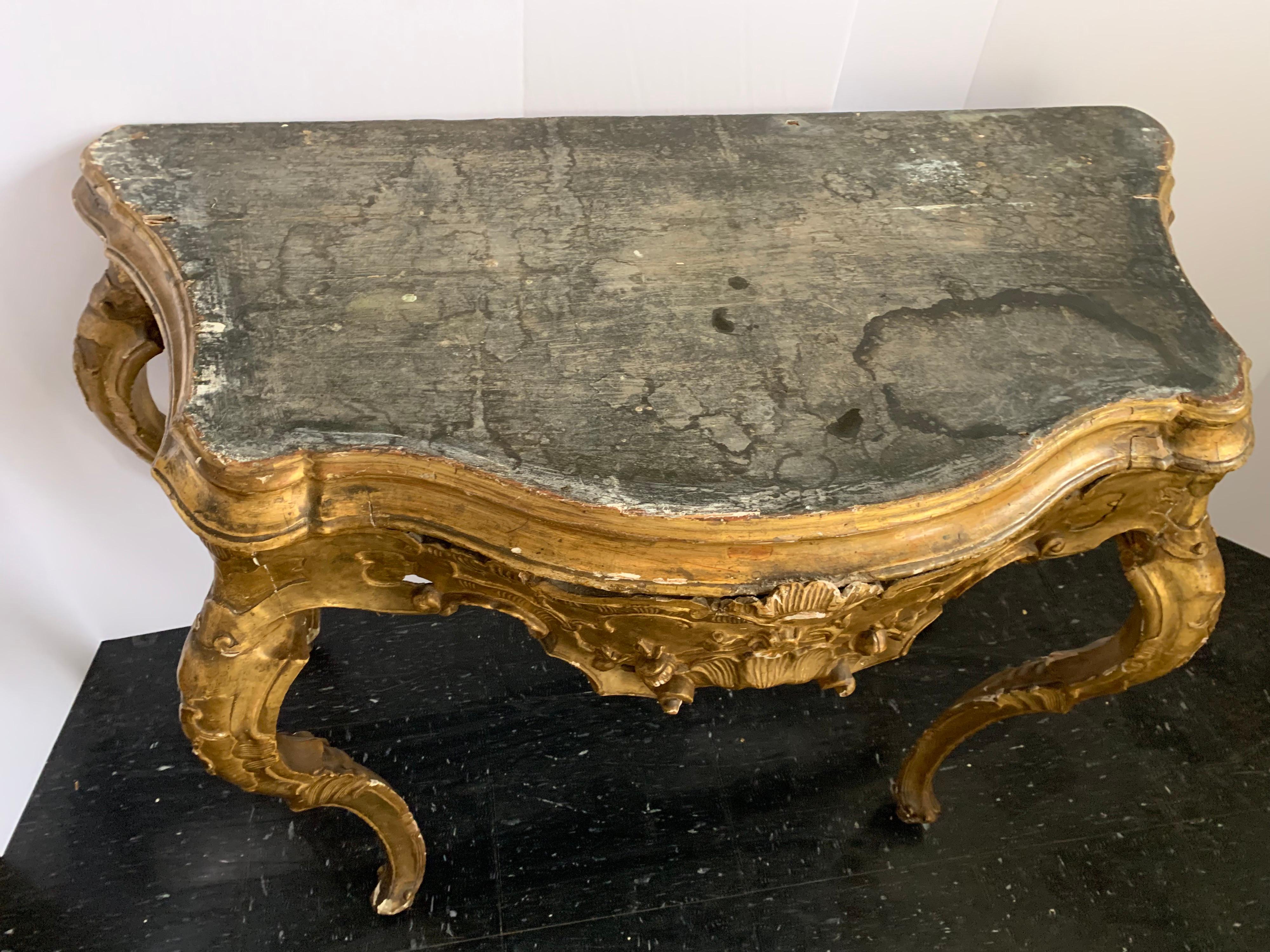 Finely wood carved Venetian console with gorgeous gilding. This is a dressy piece in any area of your home. It’s in great shape for its age as well.