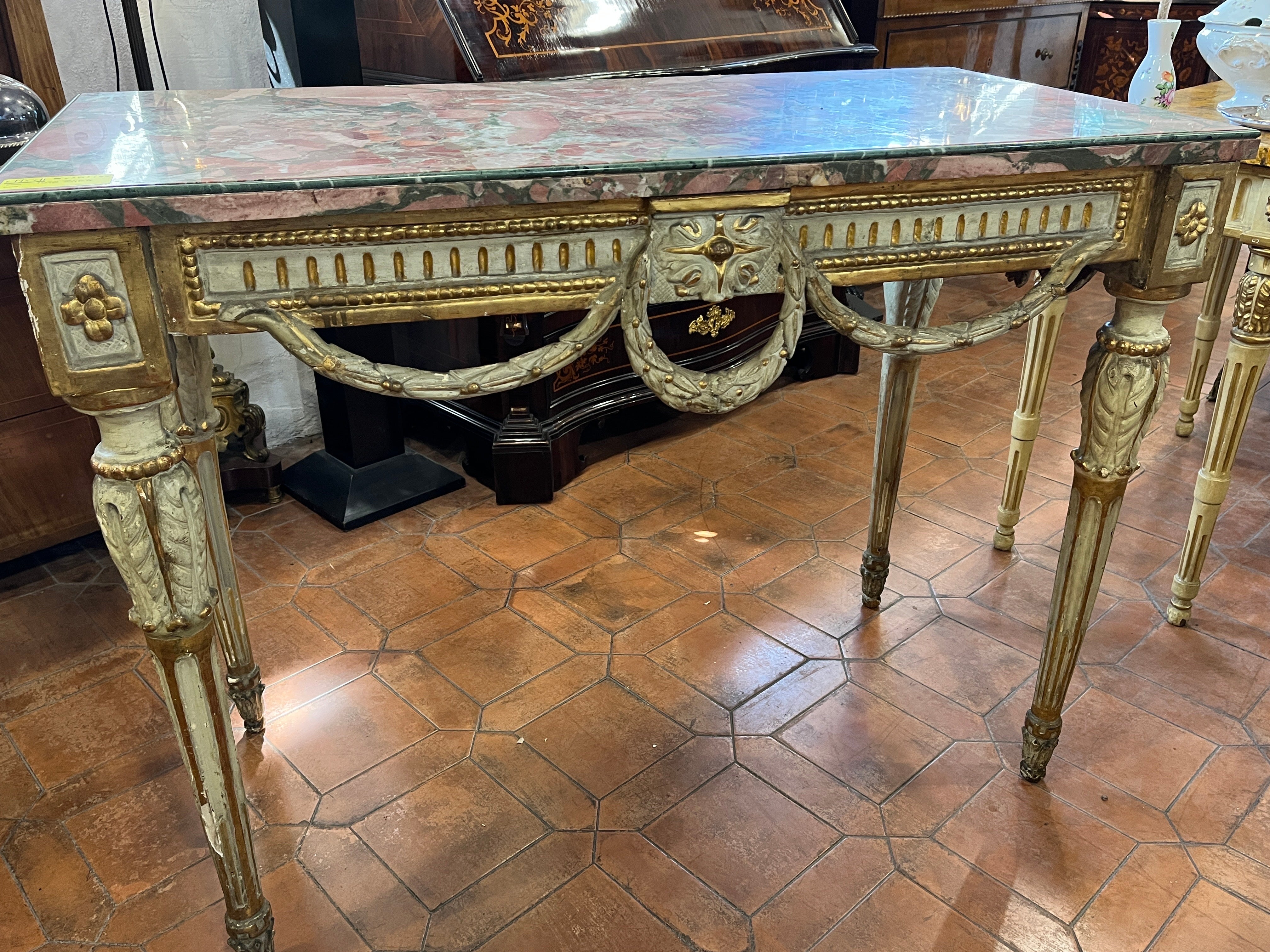 Important Italian console table, city of Venice, late Louis XV period, of incredible beauty and proportions. Finely hand-carved with shapes of flowers and acanthus leaves on the legs and garlands joining on three sides. The marble is of pernicious