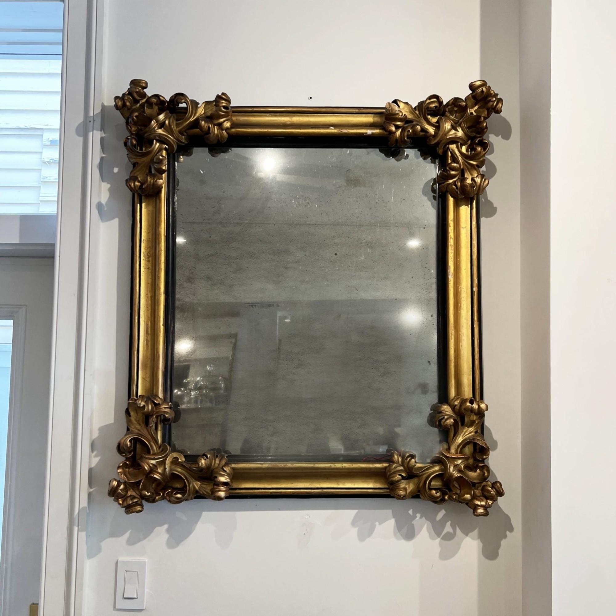 Rectangular mirror with the most extraordinary embellished corners.  Deep, ornate carving.