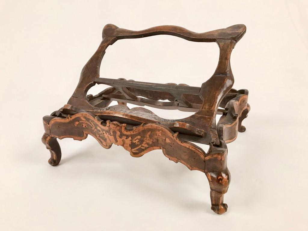 A rare and beautifully designed carved walnut book stand with fruitwood inlay. The epitome of Rococo with undulating curves on all sides as well as robust cabriole legs. The adjustable stand the perfect place to show, or just read, a favourite book.
