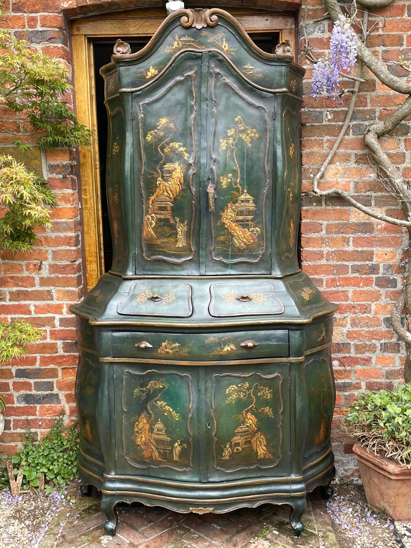 An antique Venetian rococo japanned (or 'lacquer') cabinet.

This rare and sophisticated antique cabinet separates in two, with bombé and serpentine profiles.

The particularly fine and detailed lacquer* is executed on a blue green ground and
