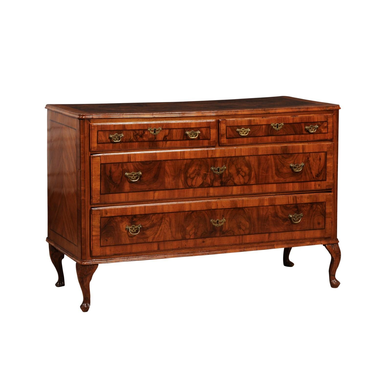 A Venetian walnut and mahogany commode from the 18th century with four drawers, bookmatched veneer, cross banding and cabriole legs. This Venetian walnut and mahogany commode from the 18th century is a testament to the opulent craftsmanship of the