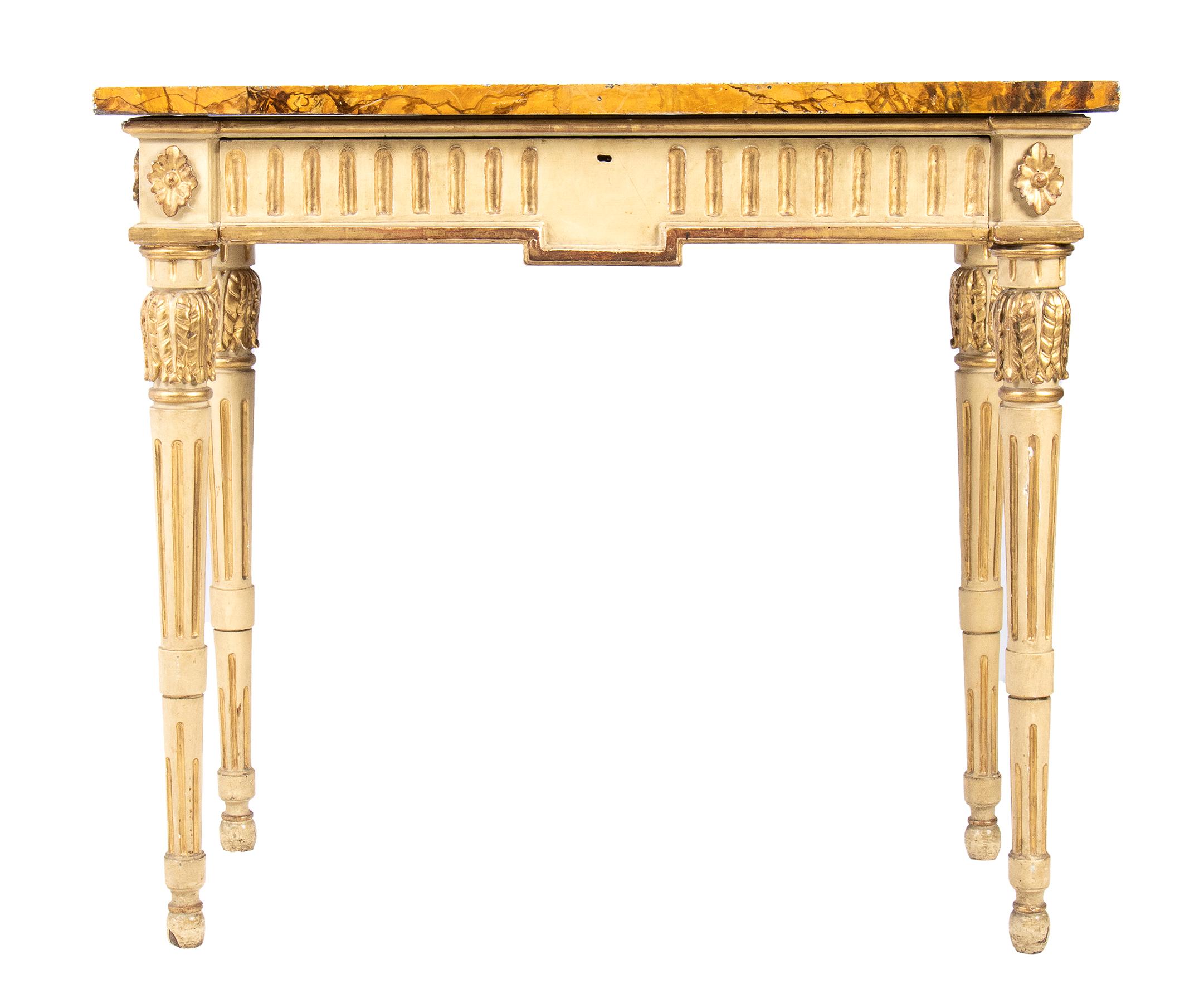 Lacquered and gilded console table - Venice, 18th century
A white and gold leaf, carved over the entire exposed structure, the front and sides decorated with laurel leaf festoons. The four truncated-cone legs are fluted and adorned at both top and