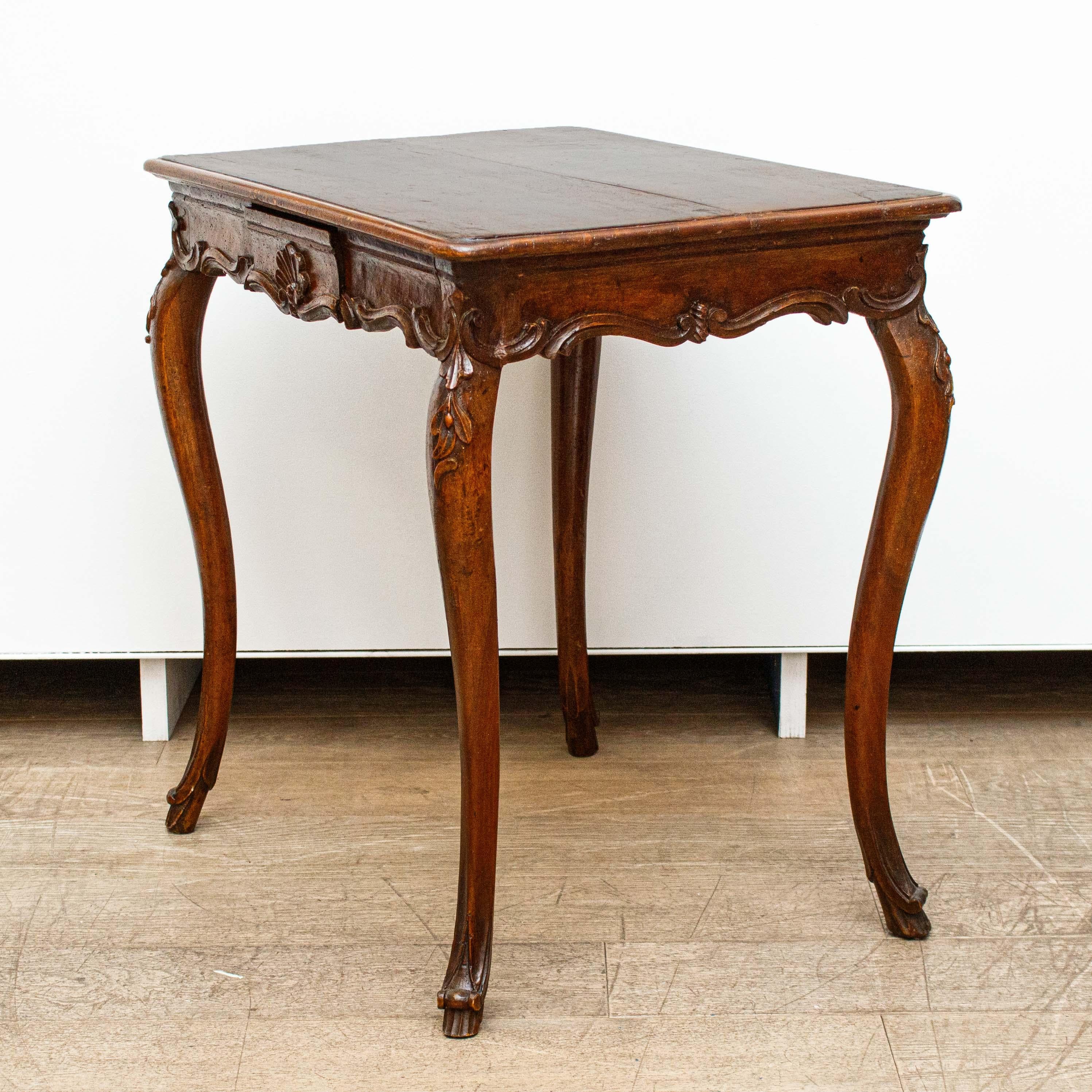 Venice, 18th century
Coffee table
Walnut wood, cm 76 x 73 x 53


Small and refined this elegant coffee table in walnut wood has a small central drawer and is finely carved with the addition of delicate vegetal and volute motifs with a central
