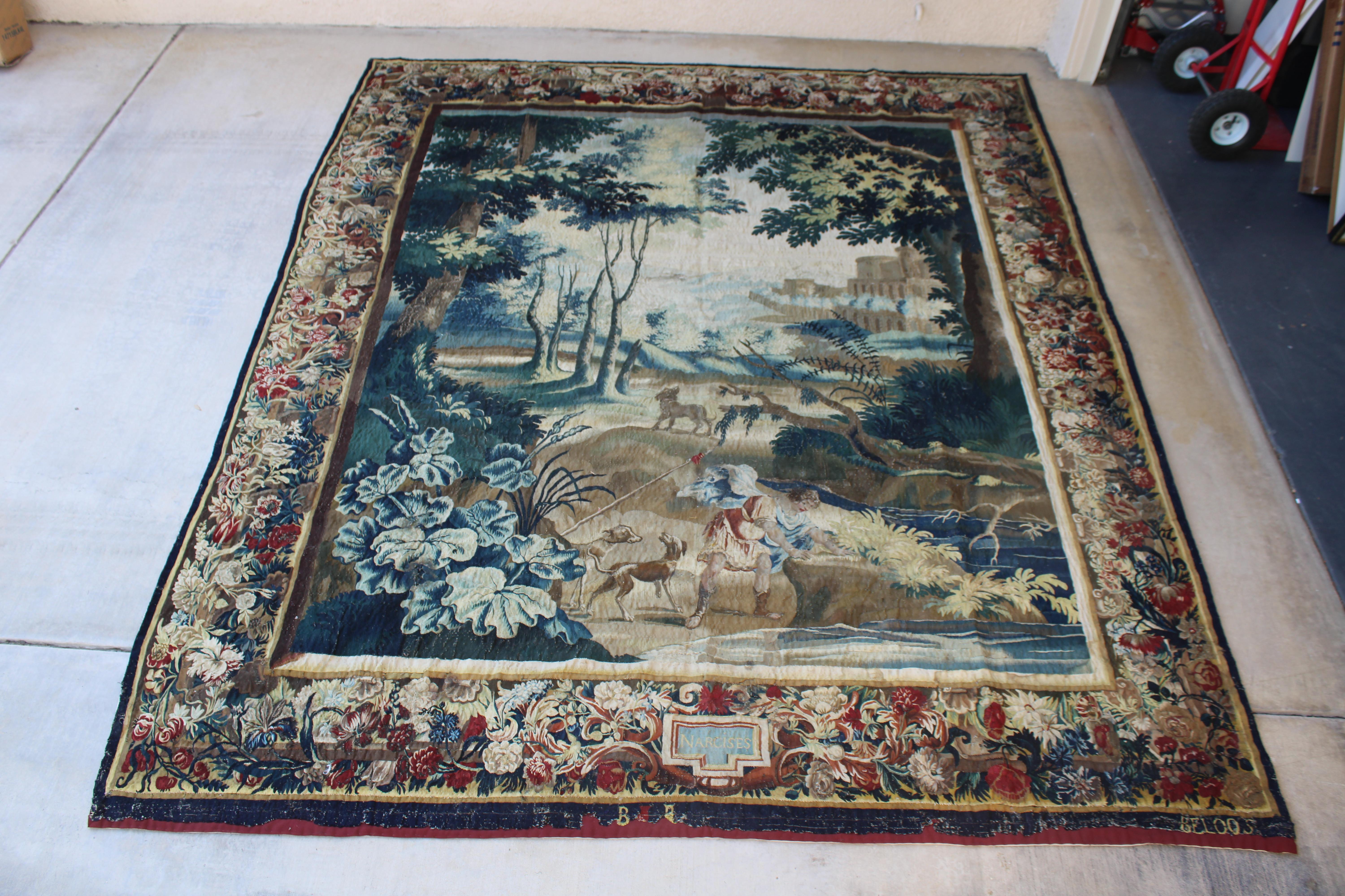 18th century Verdure tapestry measuring approximately 8 by 10 feet. Originally made popular in French courts in the 1600’s They were very popular in the French courts.  This example from the 18th century has an impressive range of colors with a rich