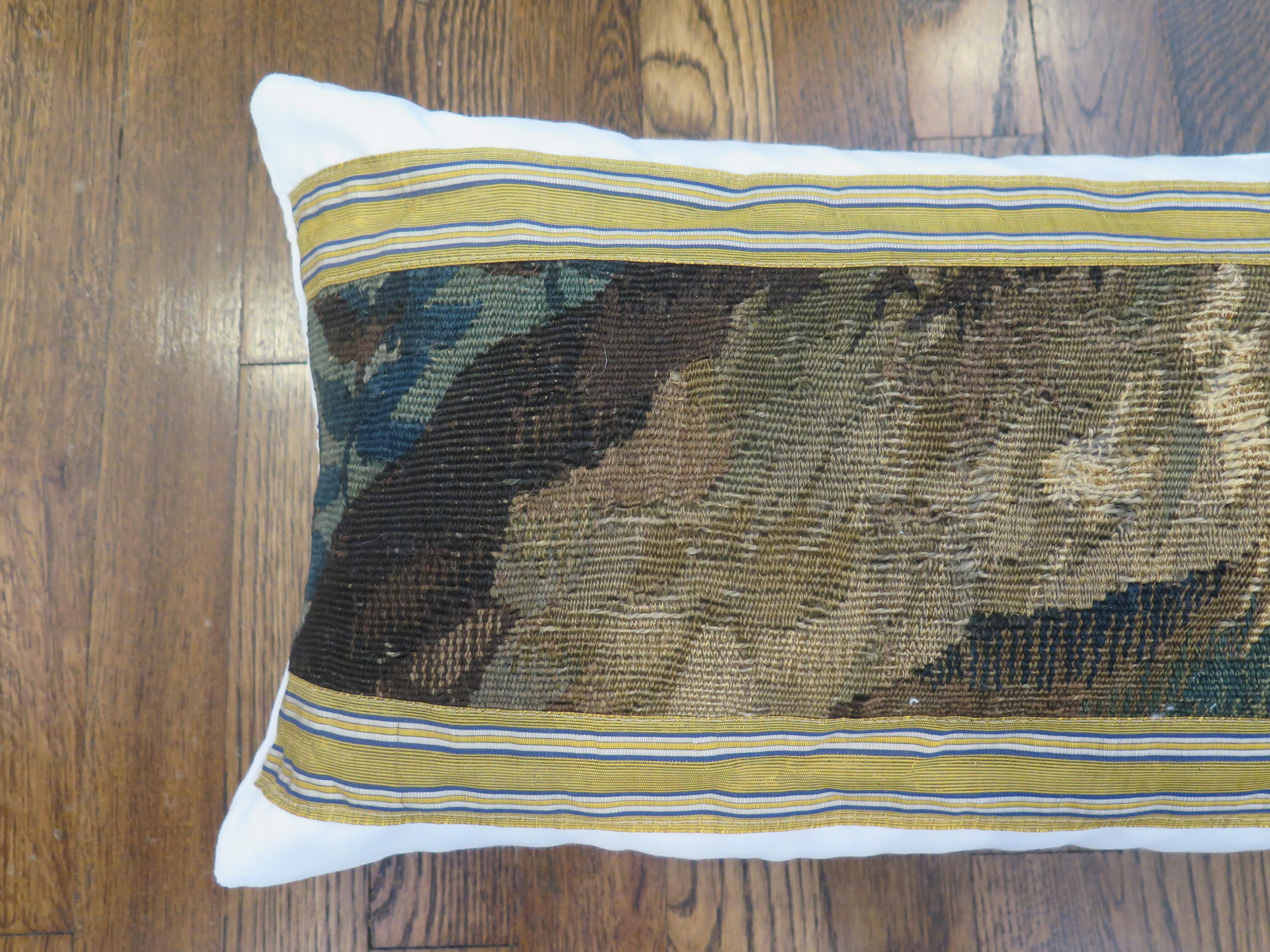 Custom 18th century verdure tapestry pillow with beautiful gold ribbon. Pillow is constructed out of holly hunt performance white velvet. Down filled.