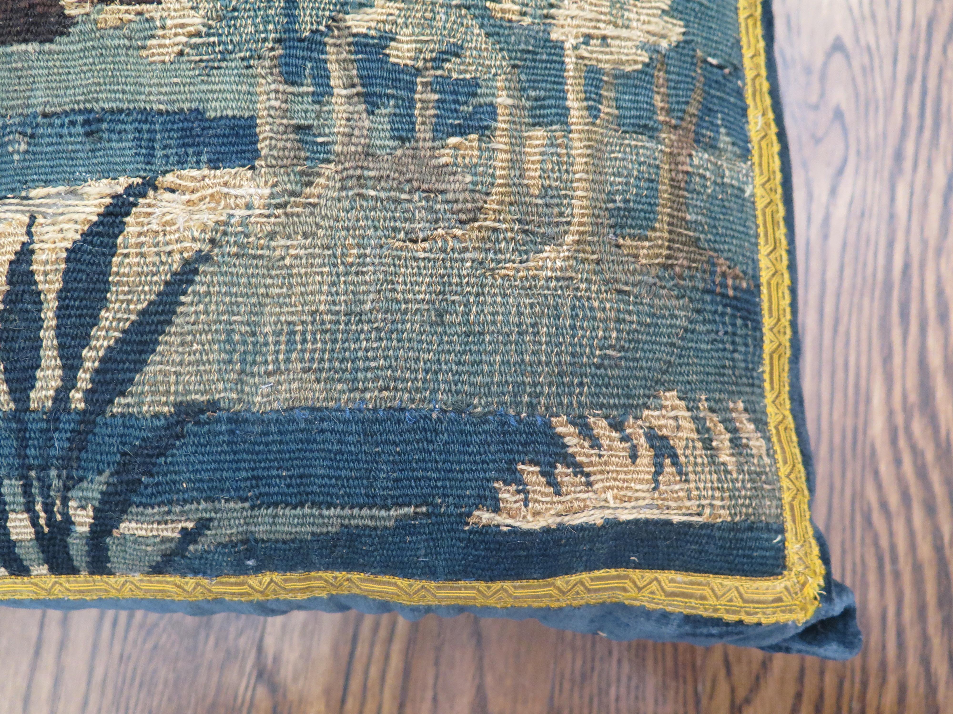 Custom 18th century verdure tapestry pillow in marine blue linen velvet and gold metallic trim. Down filled.