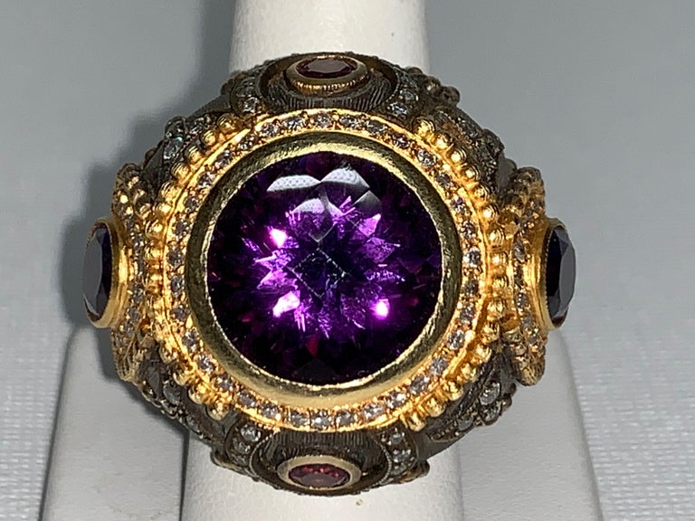 14.5 Carat Amethyst, White Diamond Ring

Featuring an exquisite 14.5 Carat Amethyst Stone; accented Round White Diamonds with a total weight of 1.80 carats, set in 18K Yellow Gold & Oxidized Sterling Silver.  

Size 7.5, This one-of-a-kind ring was