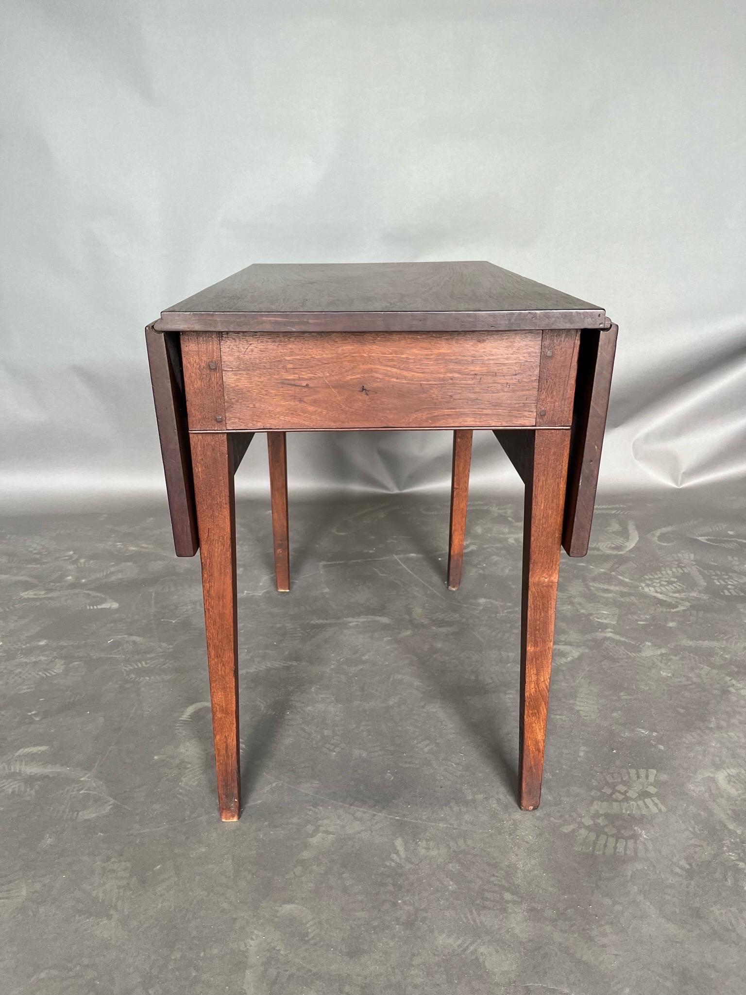 Late 18th century Virginia Tidewater walnut drop leaf table with yellow pine and oak secondaries, pegged construction, rule joints and beaded molding along the front of the apron. 