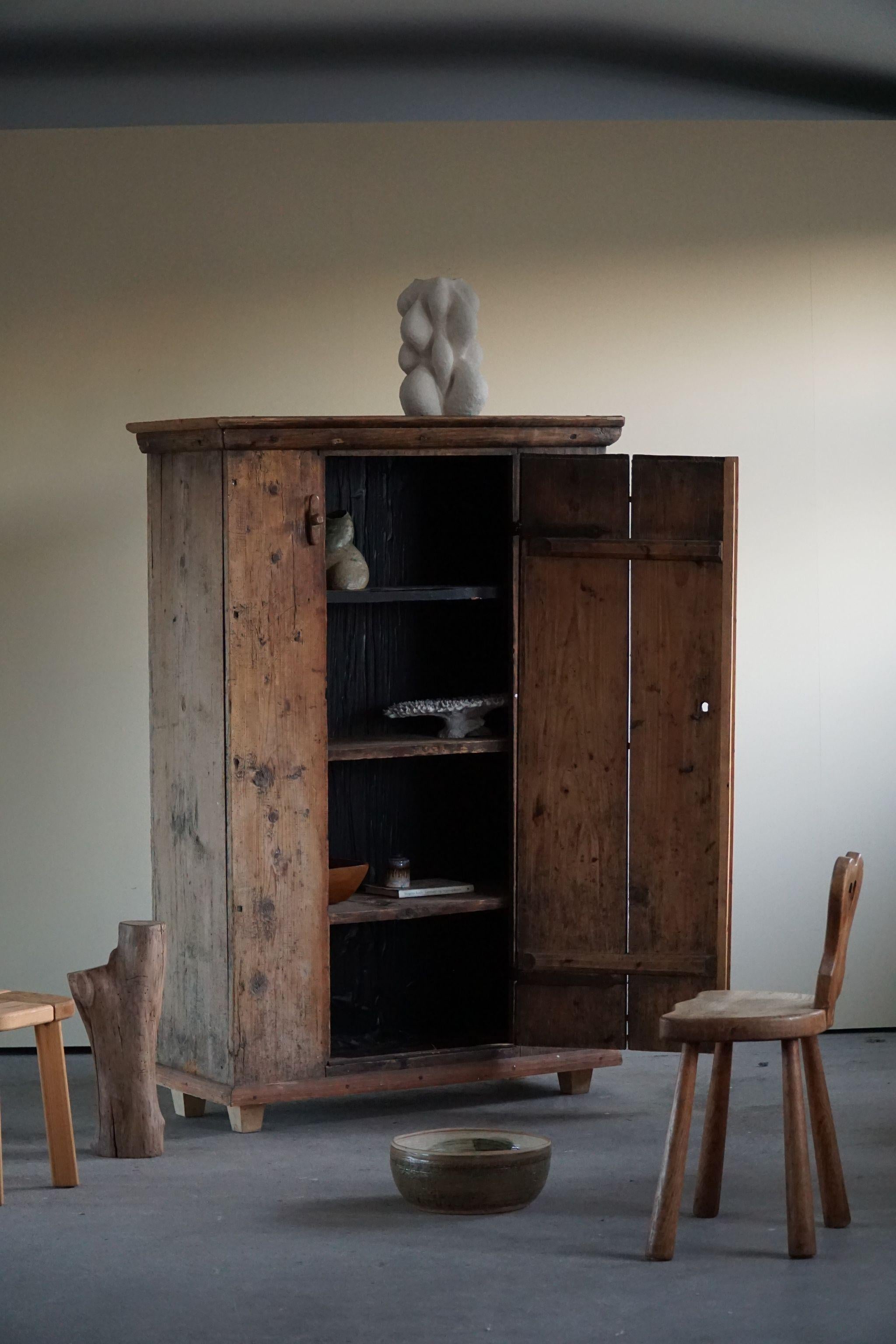 Beautiful antique cabinet in pine, made with wooden fittings. Handcrafted by a Swedish cabinetmaker in late 1700s.

A great vintage cupboard with a lovely patina. A good size with three removeable shelves that can contain your art pieces. 

A