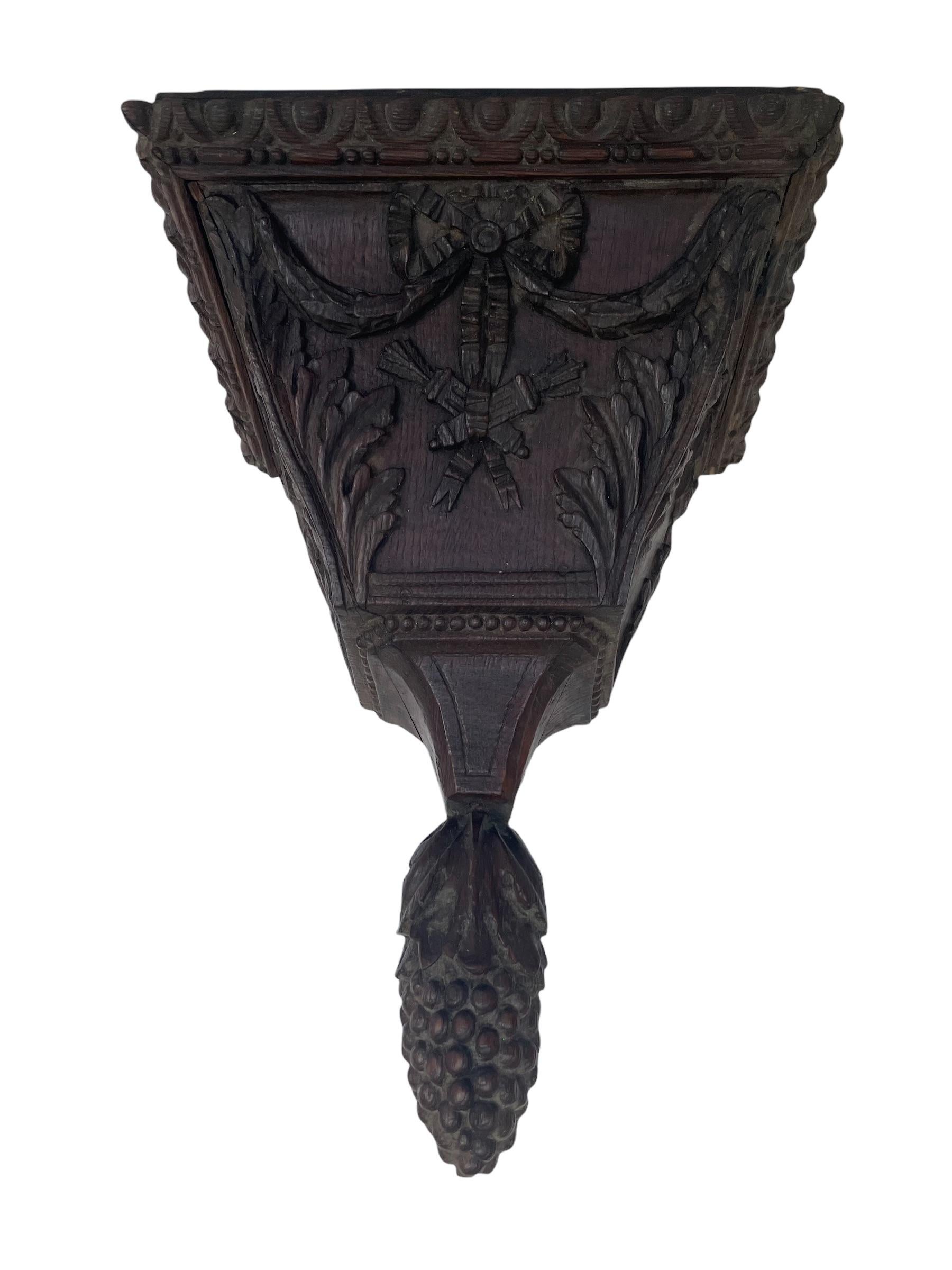 French wooden console decorated with carved bows and ribbons.