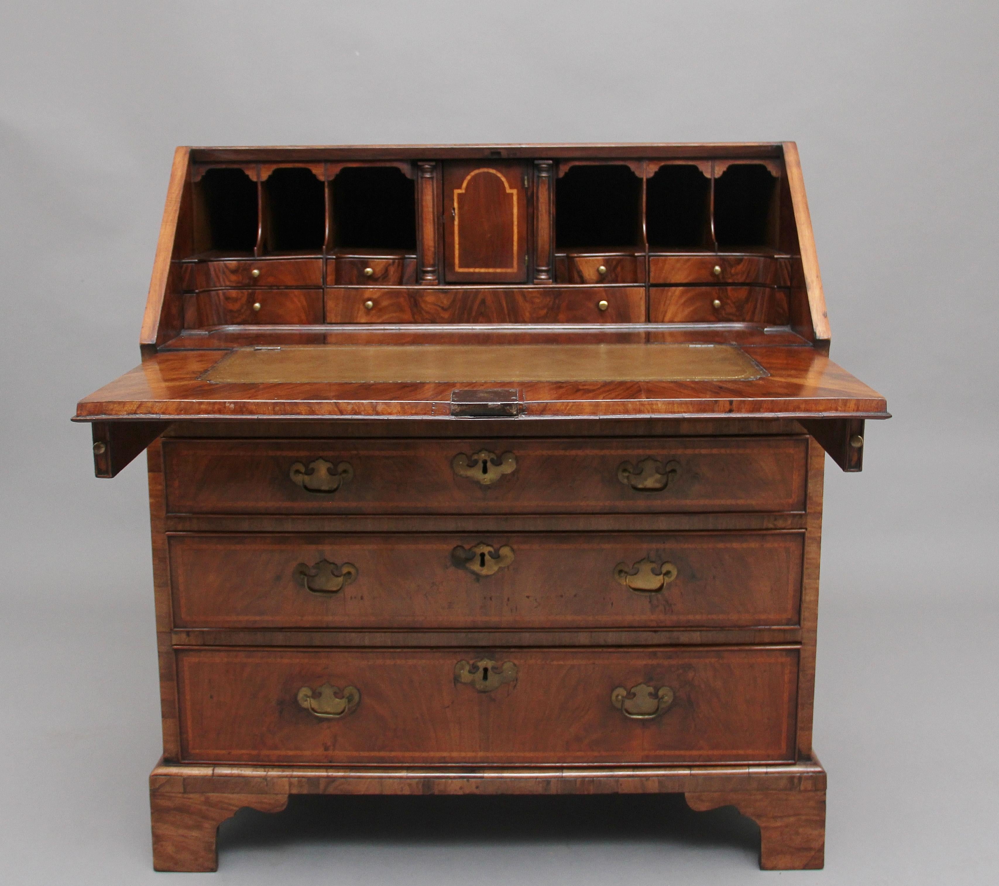 18th century walnut and feather banded bureau, having a lovely figured fall which open to reveal a wonderful fitted interior consisting of various drawers and compartments, including a cupboard door at the centre which opens to include a secret