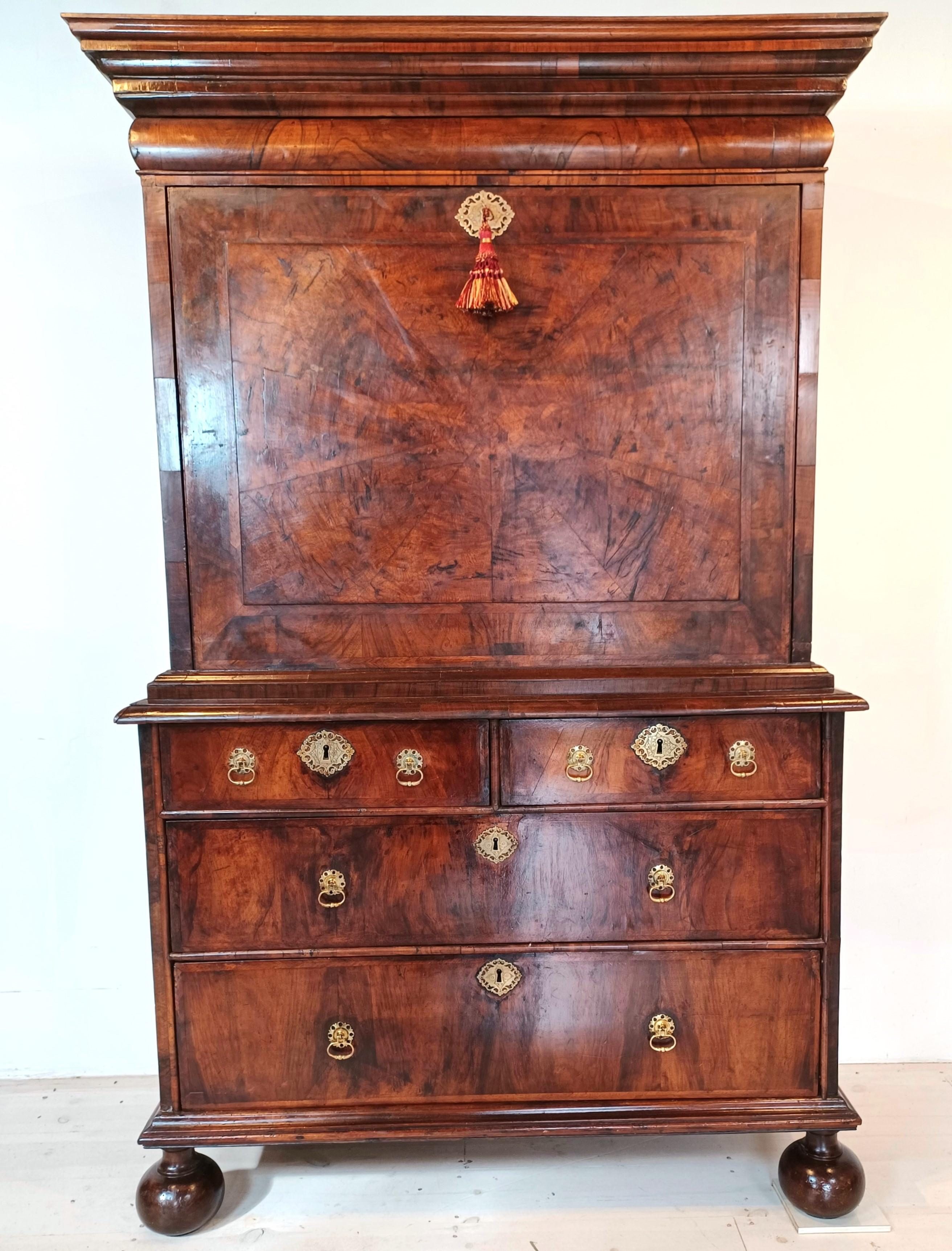 A lovely walnut and pollard oak Queen Anne period secretaire en abbatant circa 1710 -1720 .
This piece consists of a top frieze drawer, and a fall with drawers below.  Inside the fall are 10 drawers and 3 sliding compartments. There are another