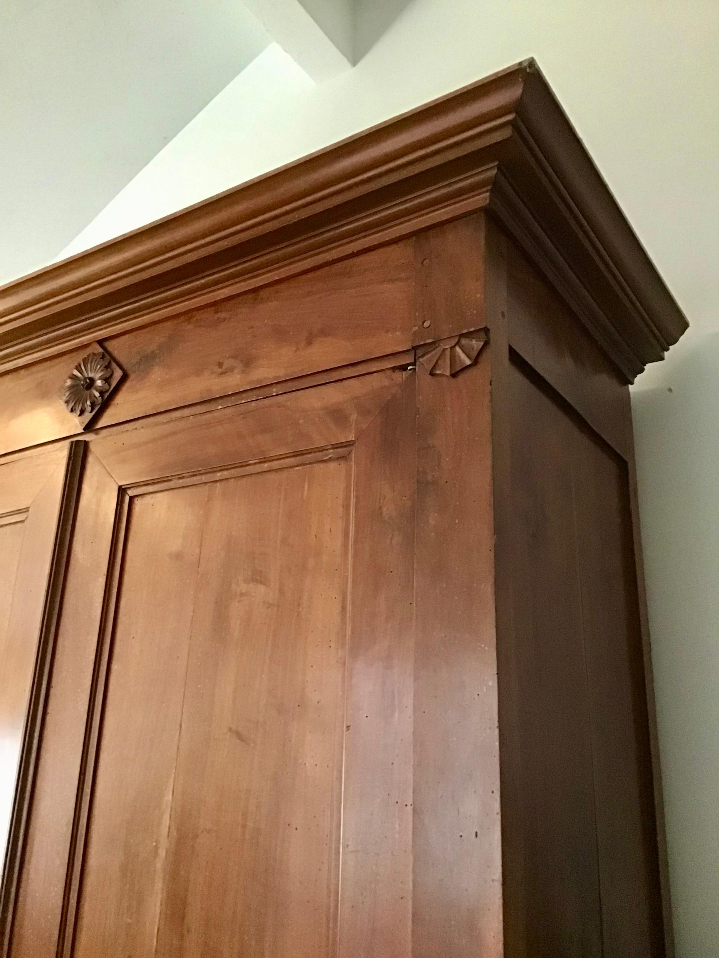French Armoire in original condition from the 1700s. It is shy of 9 feet tall. It is roomy enough inside for two shelves and hanging clothing, or for a large TV, or even as a toddlers bed.