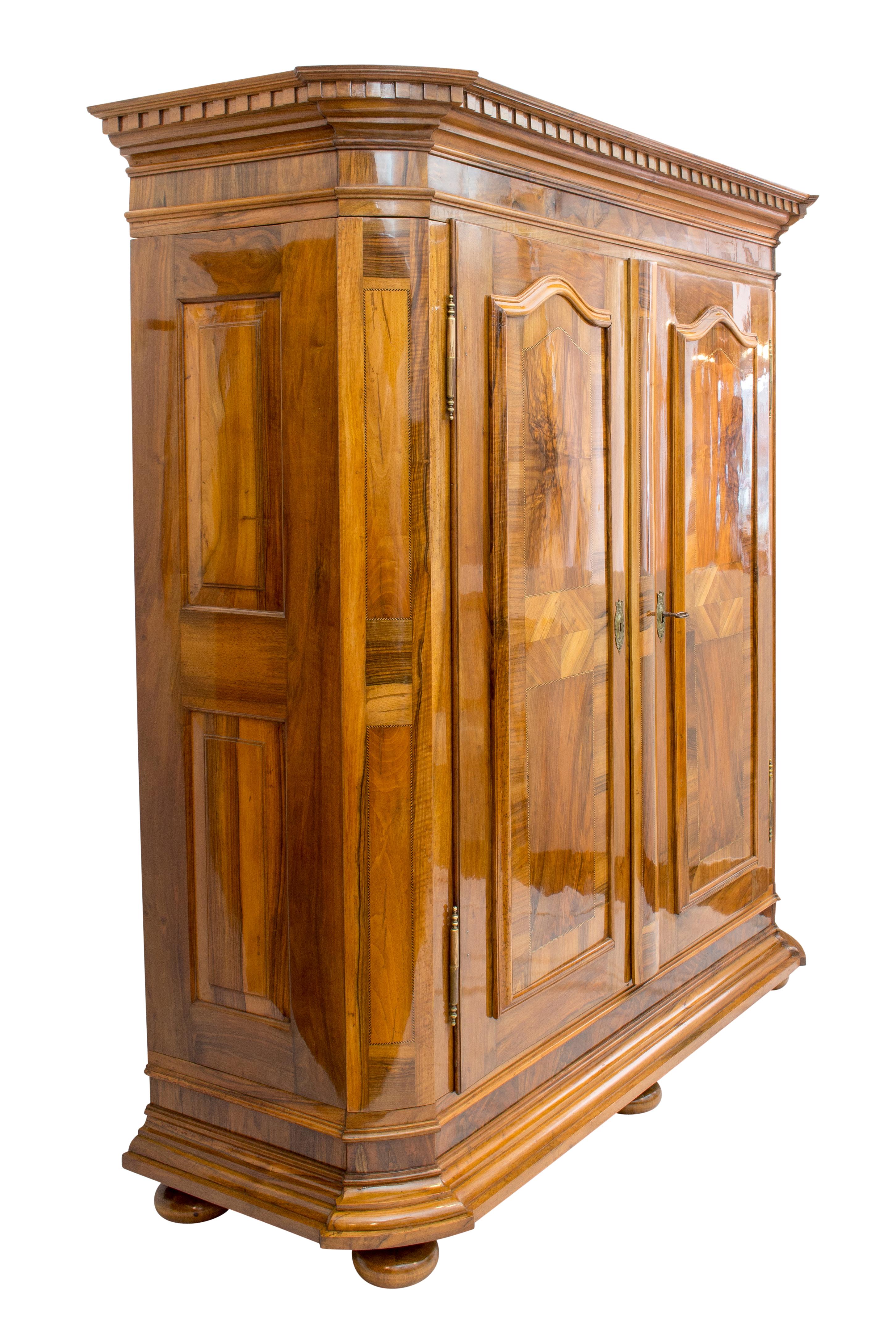 Significant Palatinate Baroque cabinet from West Germany / border area to France. The cabinet dates back to the Baroque period circa 1750 and was made of solid walnut wood and veneered. The front is decorated with fillet ribbons and a contrasting