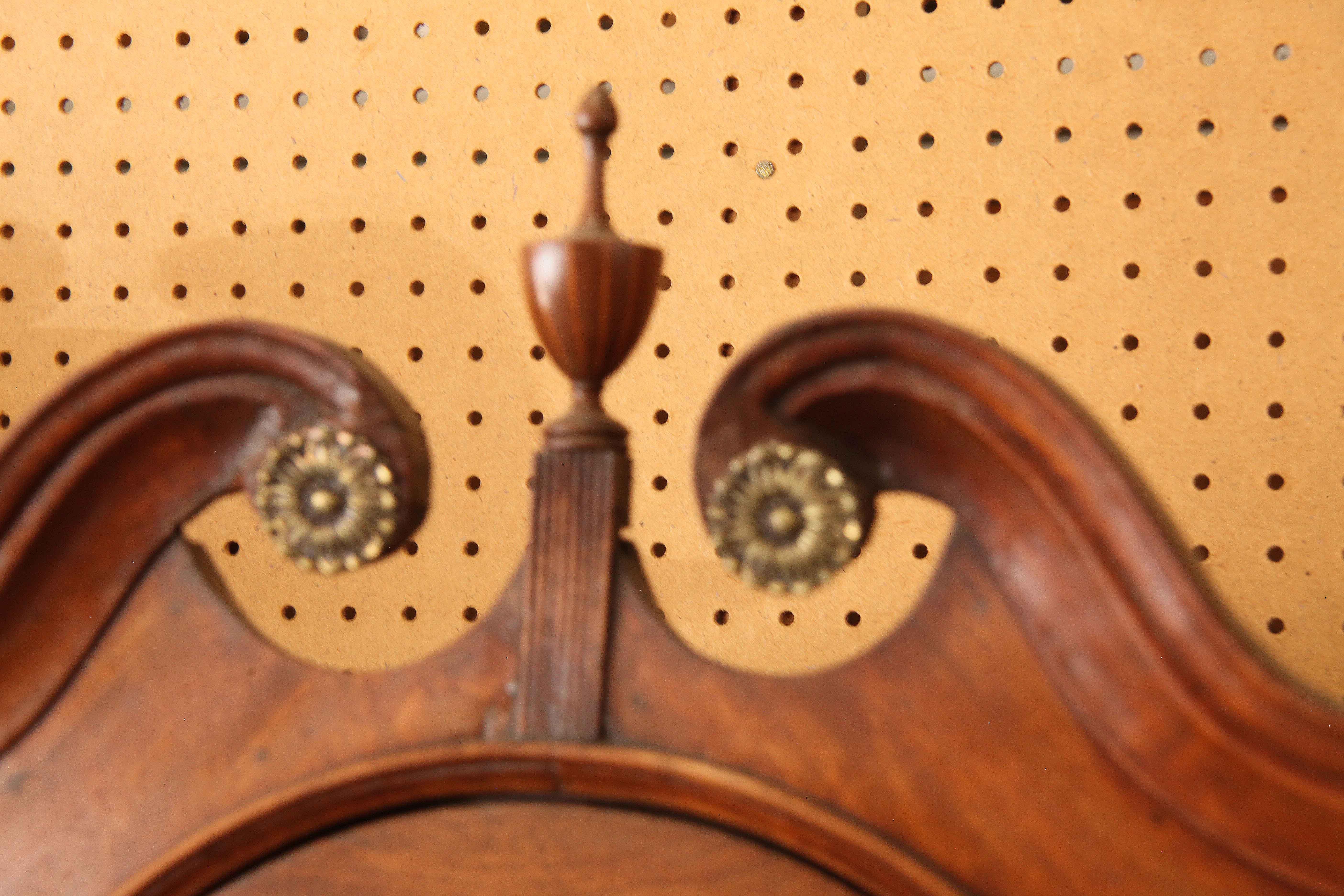 18th century walnut brass dial grandfather clock, the bonnet has a beautiful broken arch swan neck pediment with brass rosettes , reeded keystone and inlaid urn finial.  The brass dial with round plaque reading 