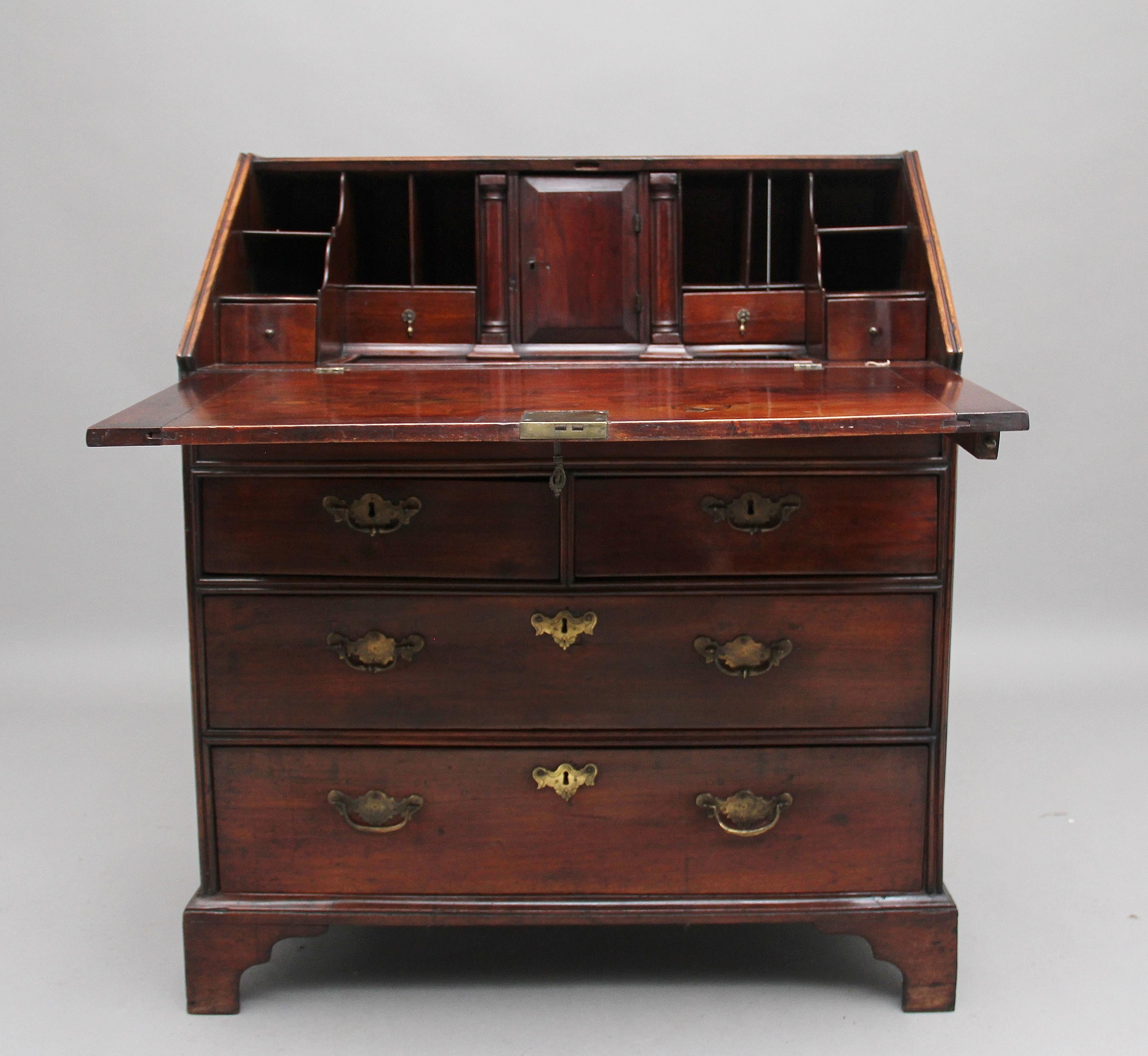 18th century walnut bureau, the top having a double moulded edge with the fall opening to reveal a lovely fitted interior, with various drawers, compartments and a well, the writing surface of fall having a lovely figured top, two short over town
