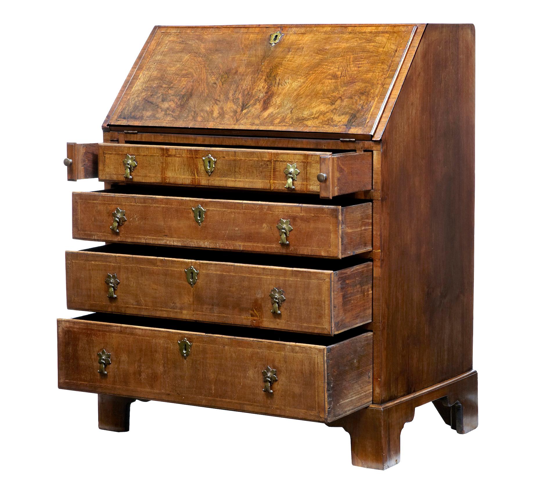 Good quality 18th century walnut bureau of small proportions circa 1780.

Fall and drawer fronts veneered in walnut with cross banding detail. Fall drops down to form a writing surface and fitted interior of pigeon holes over 4 drawers.

4