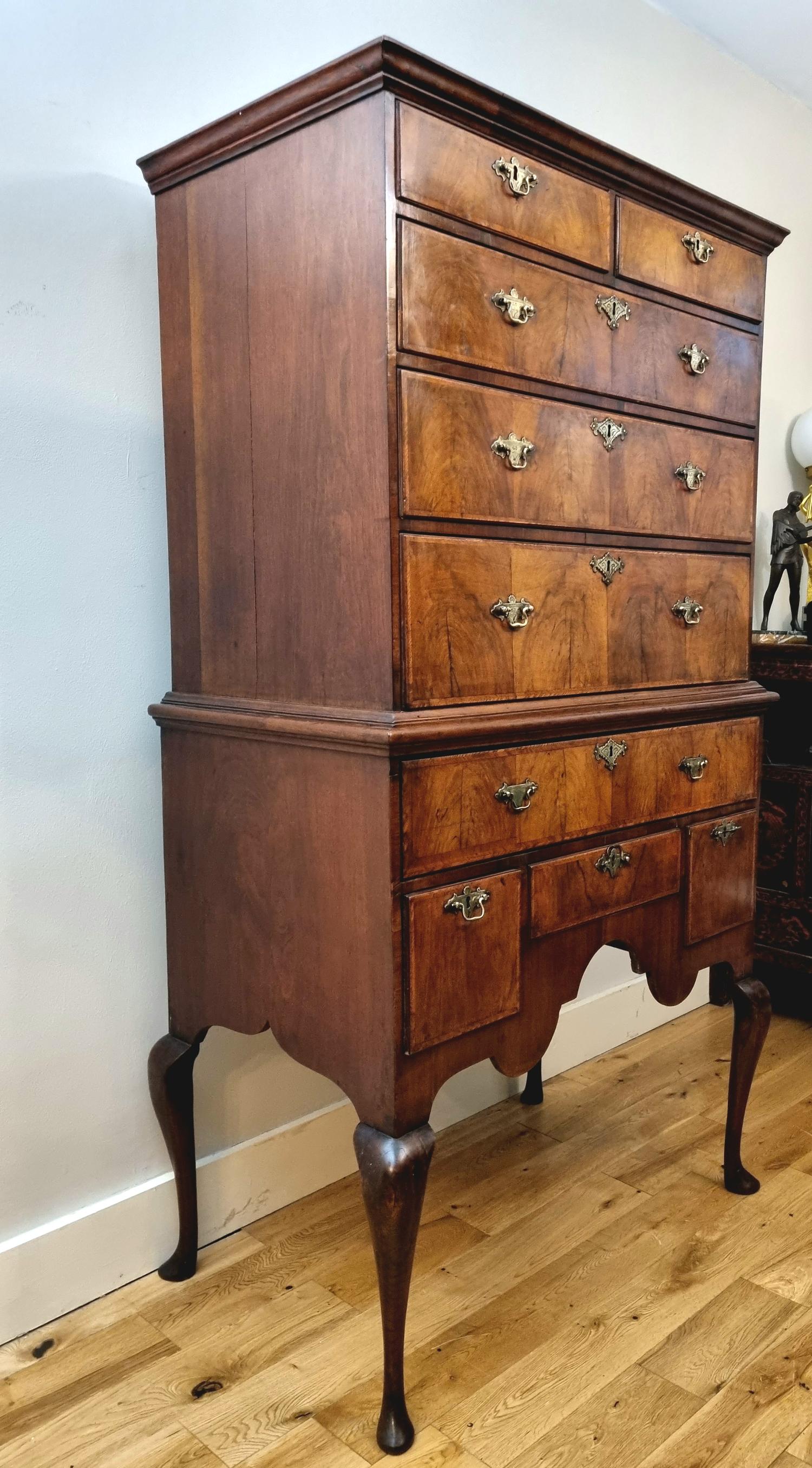 An exceptional early 18th Century Queen Anne period Walnut Chest On Stand / Highboy , dating to 1702-14 .

Impeccable colour and patina . Beautiful figured walnut veneers with delicate feather banding to the edges of the drawers . Original chased