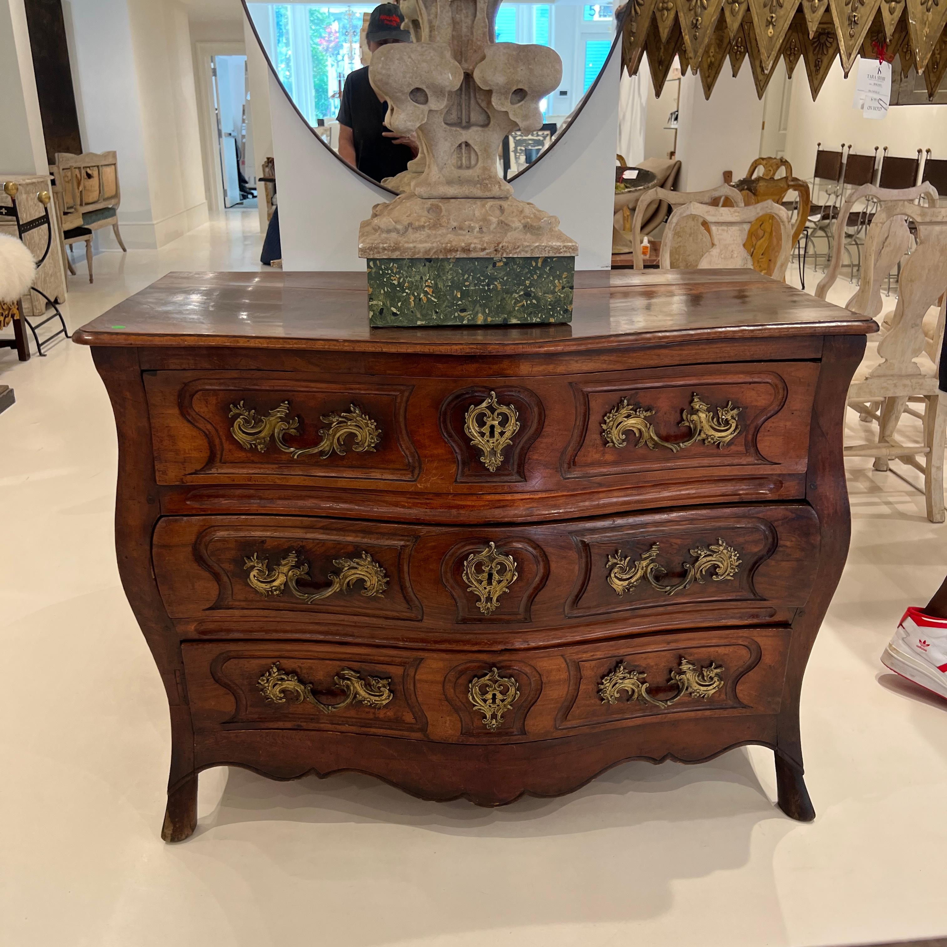 
This lovely piece is the quintessential example of a well crafted French commode. The proportions are pleasing, the details are superb with carving on side panels and the front apron. The pulls and key hole escutcheons are oversized and impressive.