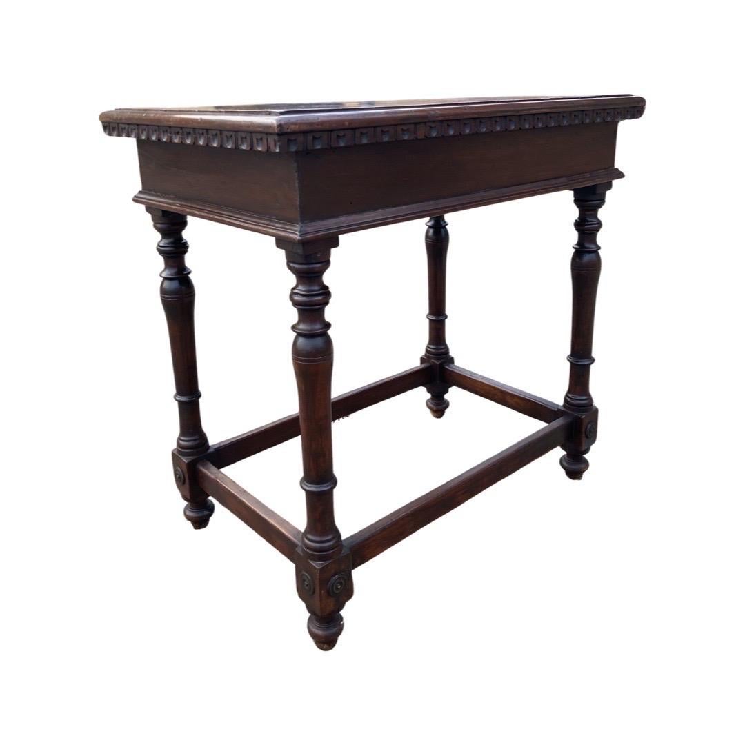 Side table hand-made in Italy in the mid 1700s using walnut. This little guy is a an absolute show-stopper, despite its small size. The top is made from one single board with ogee edge, decorated with a hand-carved notched frieze showing the typical