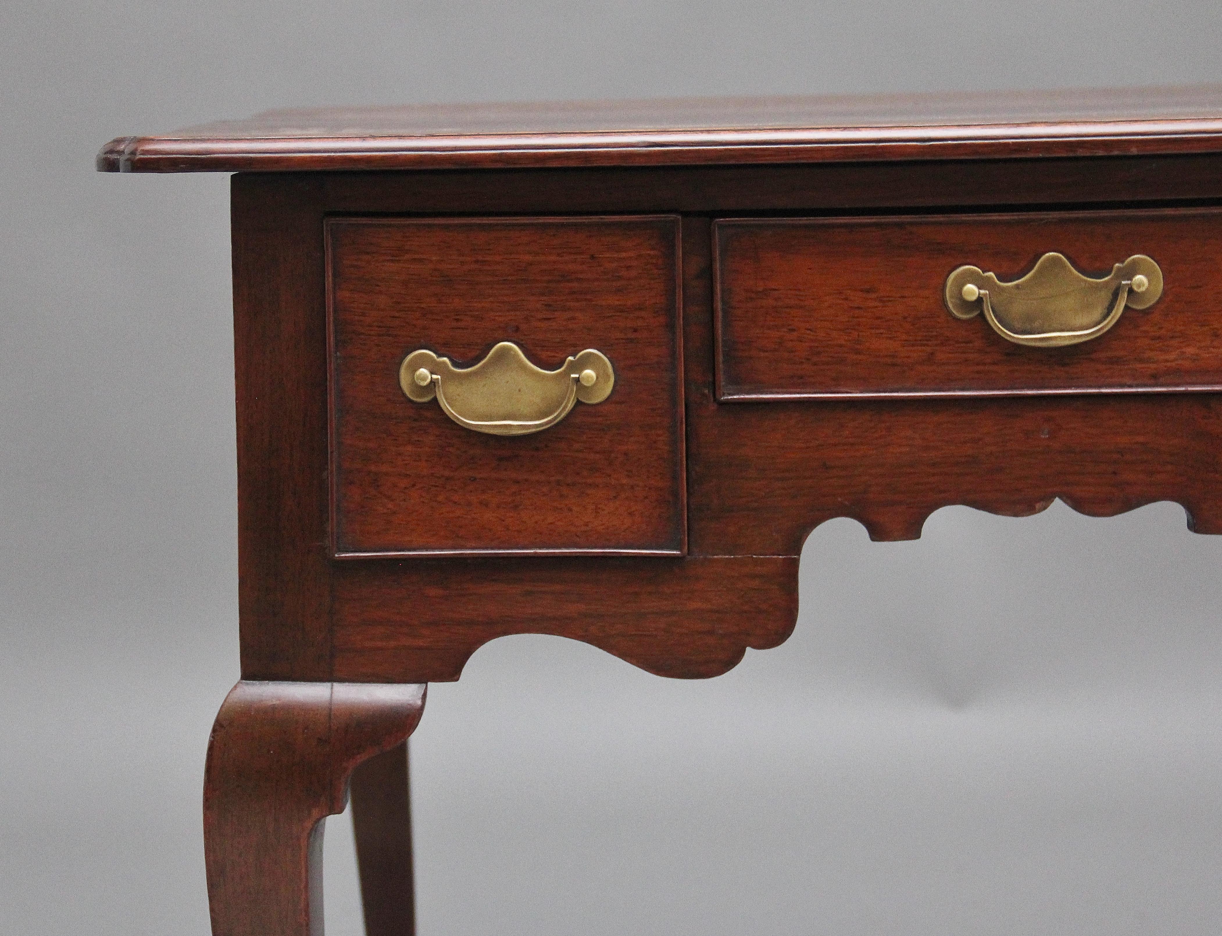 A lovely quality 18th Century walnut lowboy having a wonderful figured top with a thumb moulded edge and shaped corners, three oak lined drawers below with the original brass plate handles, highly decorative shaped apron to the front and sides and