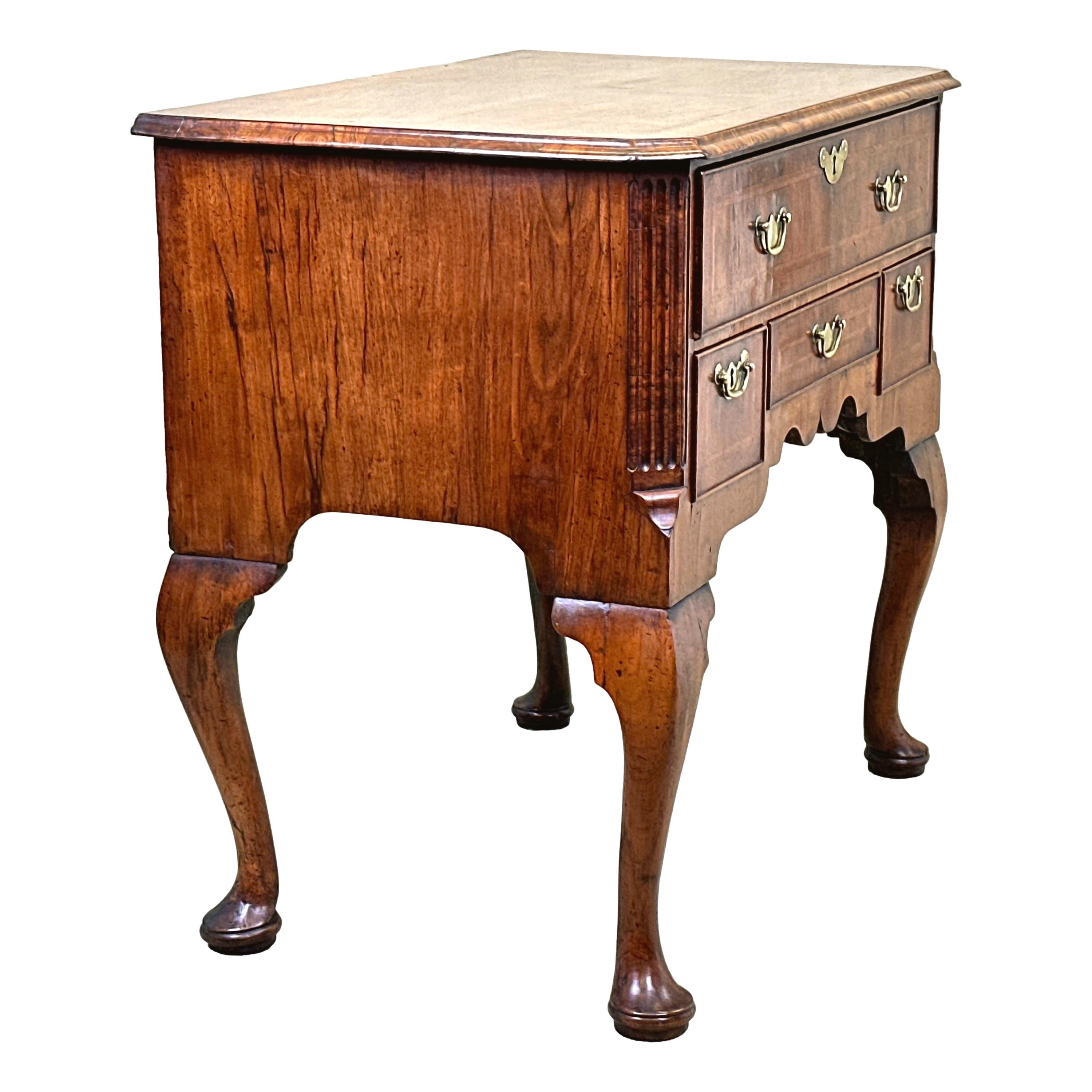 A Delightful Early 18th Century George I Period Walnut Lowboy, Or Side Table, Retaining Exceptional Untouched Colour And Patina Throughout, With Well Figured Quarter Veneered And Feather Banded Top, Over One Long And Three Short Drawers, With