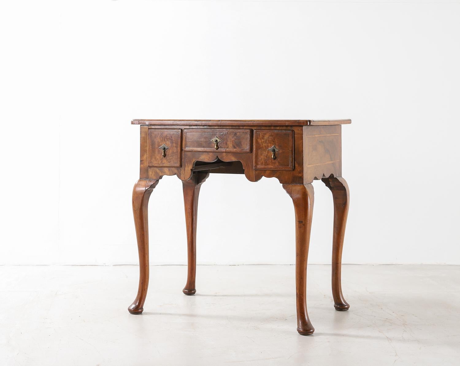 18th century walnut lowboy with three drawers with small brass handles and cabriole legs.