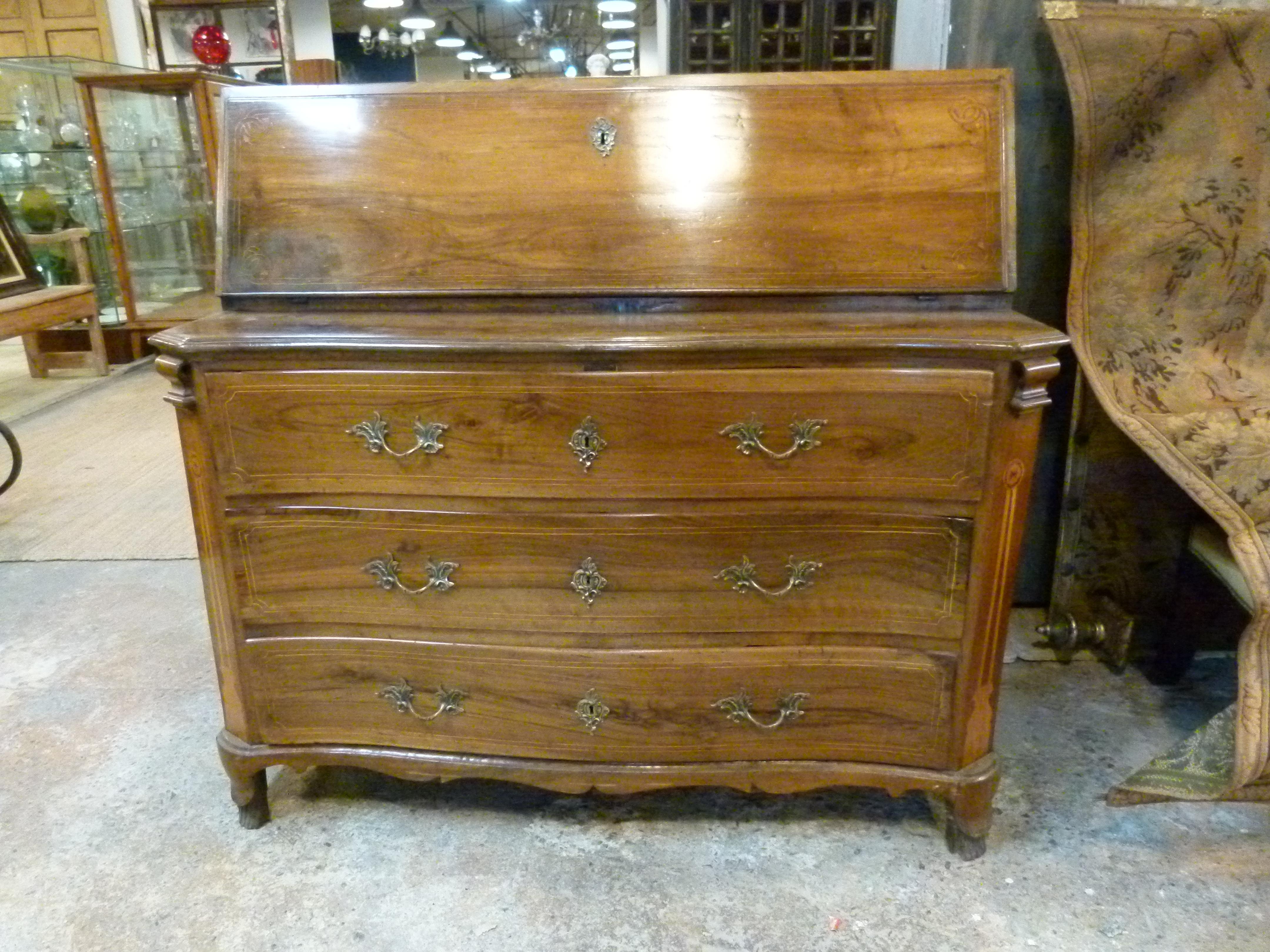 18th century secretary in Louis XVI style  in walnut. It features three large drawers on the bottom and on the top the secretary opens to five small drawers and five compartments.
    