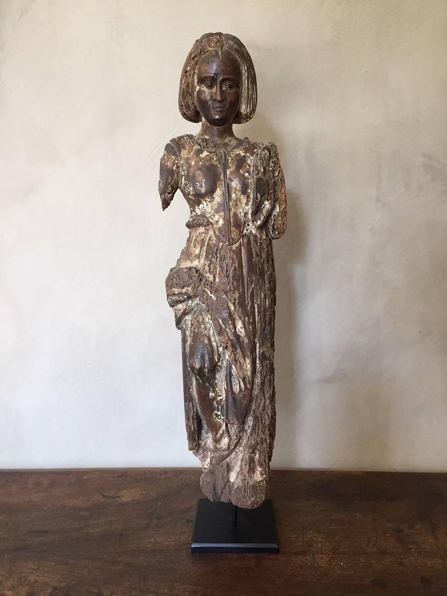 This French statue depicts the classical Goddess Minerva. Depicted without her war attributes she represents the virtue of wisdom. Not only the knowledge found in books (which probably was present in her missing right hand) but also of logical