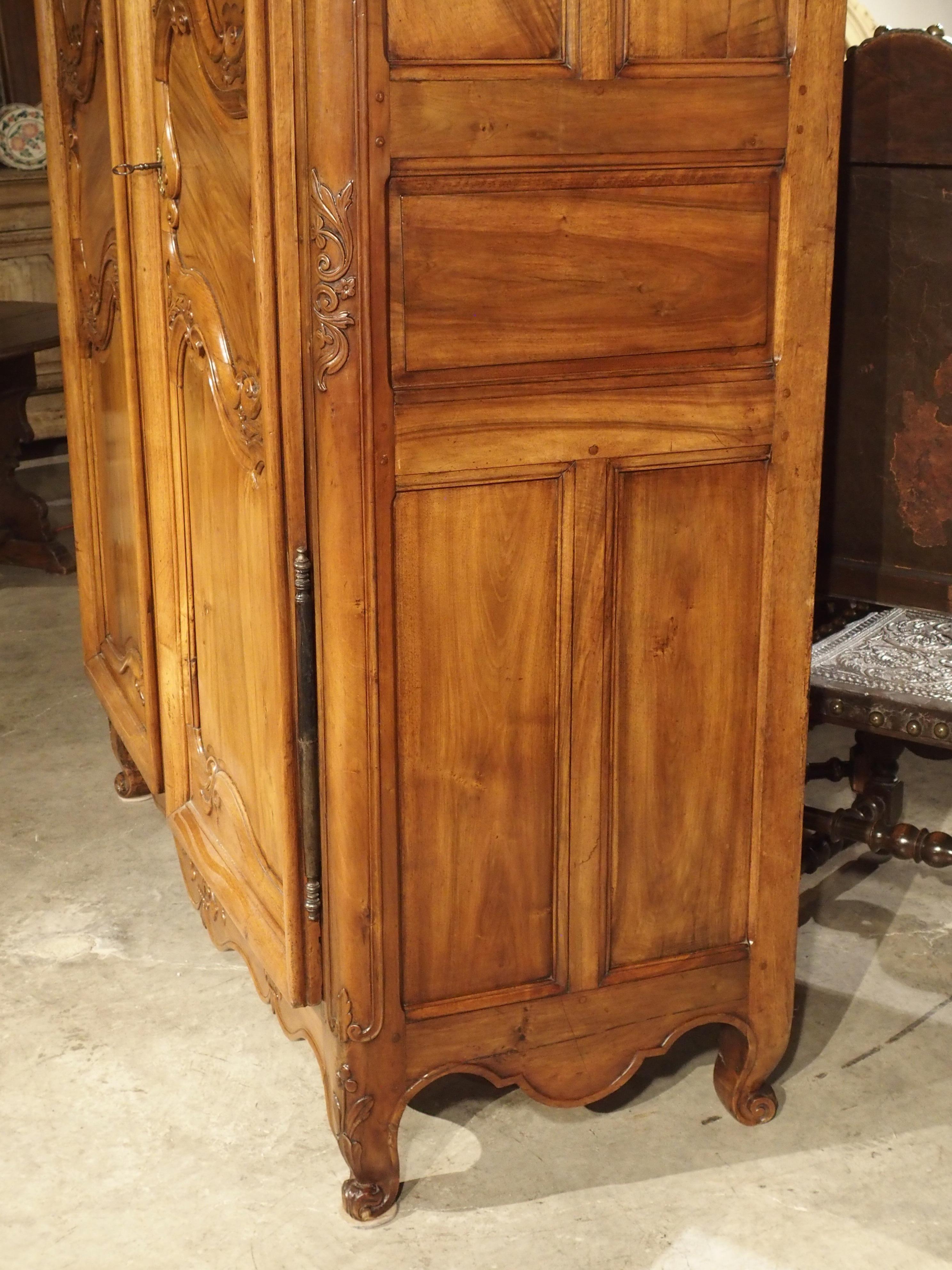This magnificent blonde walnut wood armoire from the Vallee du Rhone is from the mid 1700’s during the Louis XV period. During the reign of Louis XV, asymmetry in furniture lines was all pervasive, with curved lines softening forms and motifs.