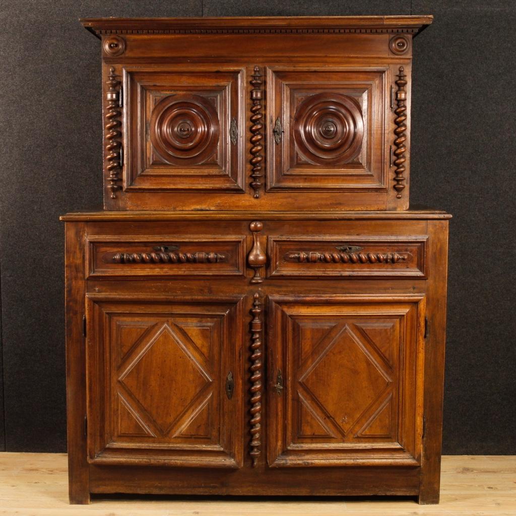 Antique French double body cupboard from 18th century. Furniture carved in walnut wood in Louis XIII style. Double body sideboard with four doors and two drawers, of excellent capacity and service. Furniture for living room or studio of great