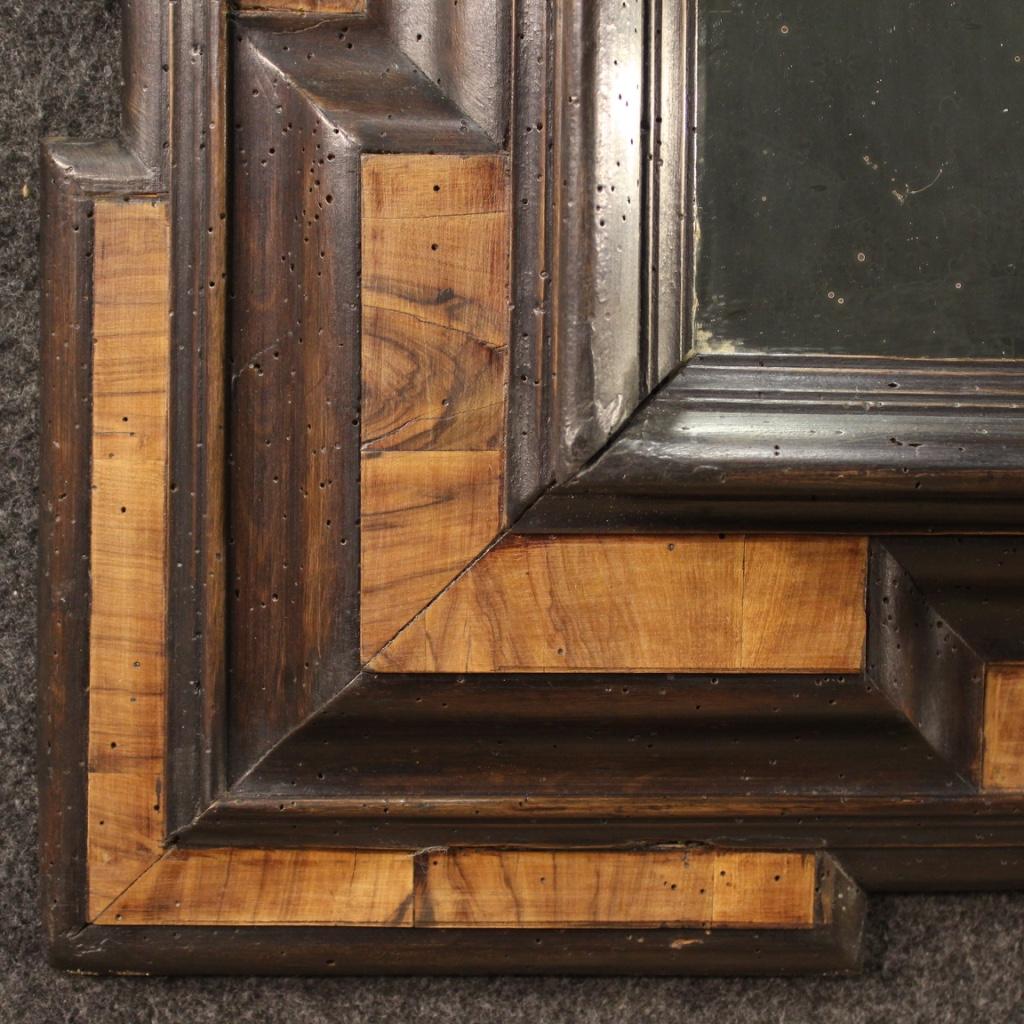 Antique Lombard mirror from the first half of the 18th century. Furniture in ebonized wood and walnut veneer of excellent quality and limited size. Mirror for antique dealers and collectors with non-original mirror, replaced during the 20th century.