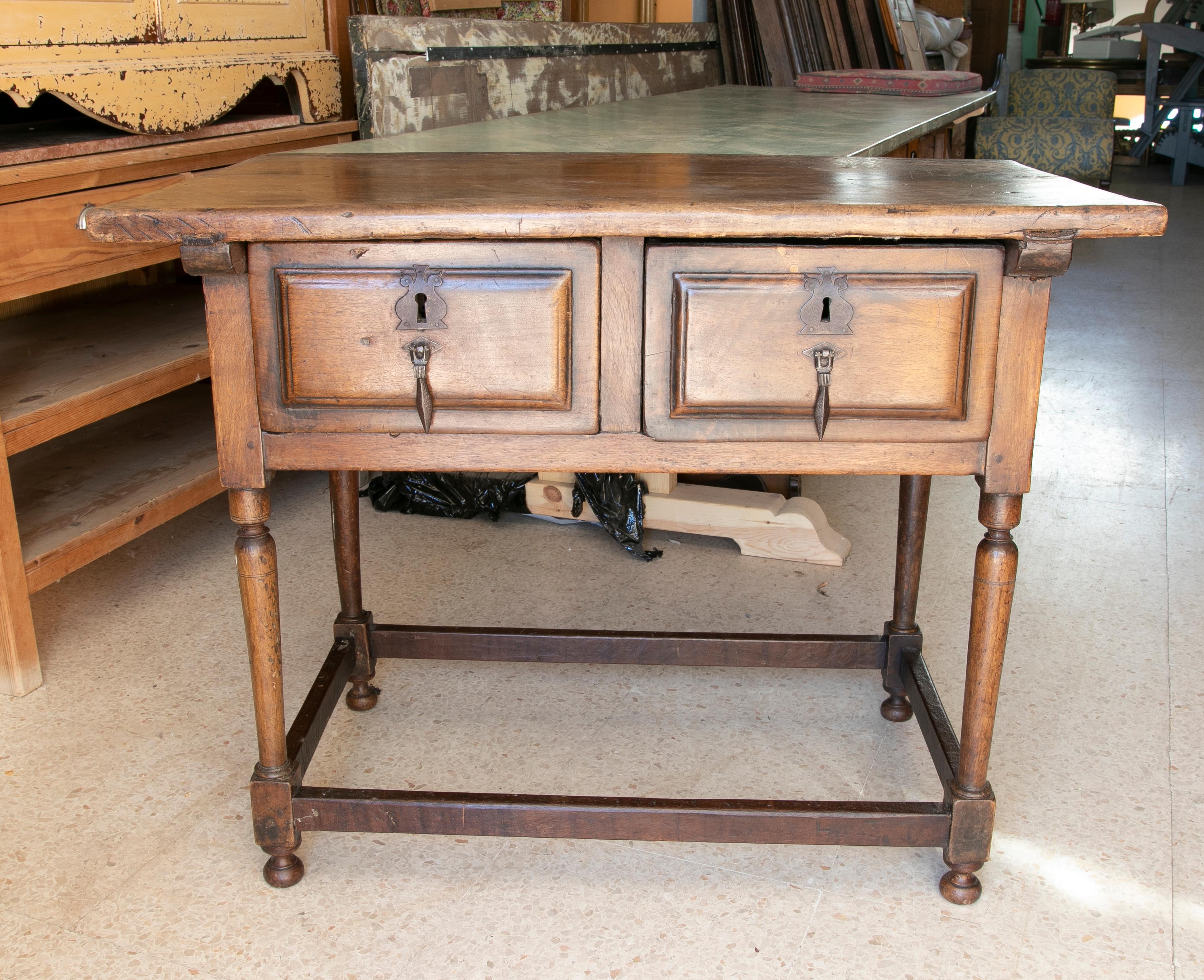 18th century walnut writing table with two drawers and antique fittings.