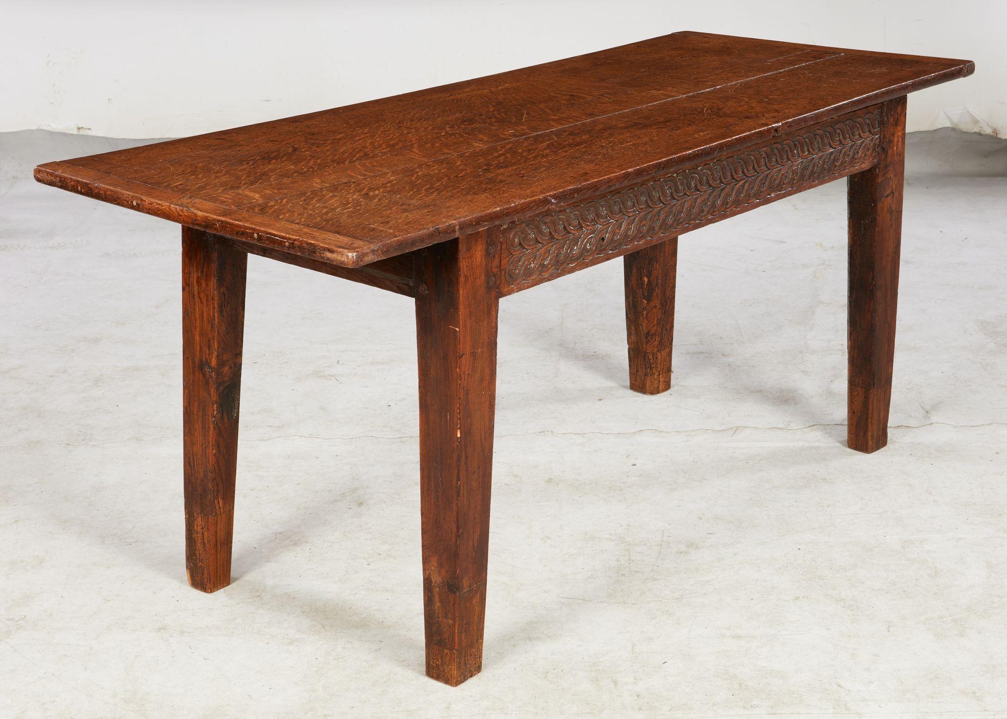 Fine 18th century Welsh oak farmhouse table, the vividly grained three plank top with breadboard ends over molded apron, the front apron carved, standing on square tapered legs with several extensions, the whole possessing good rich color and