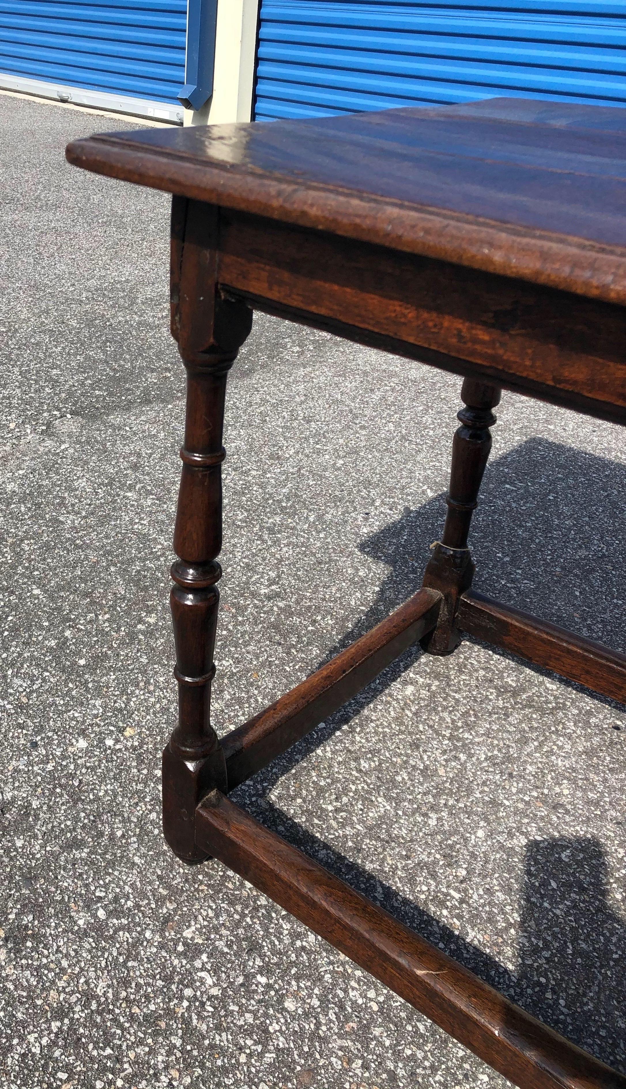 Great little 18th century welsh tavern table in oak with a box stretcher. Wonderful color and patina. Nice size.