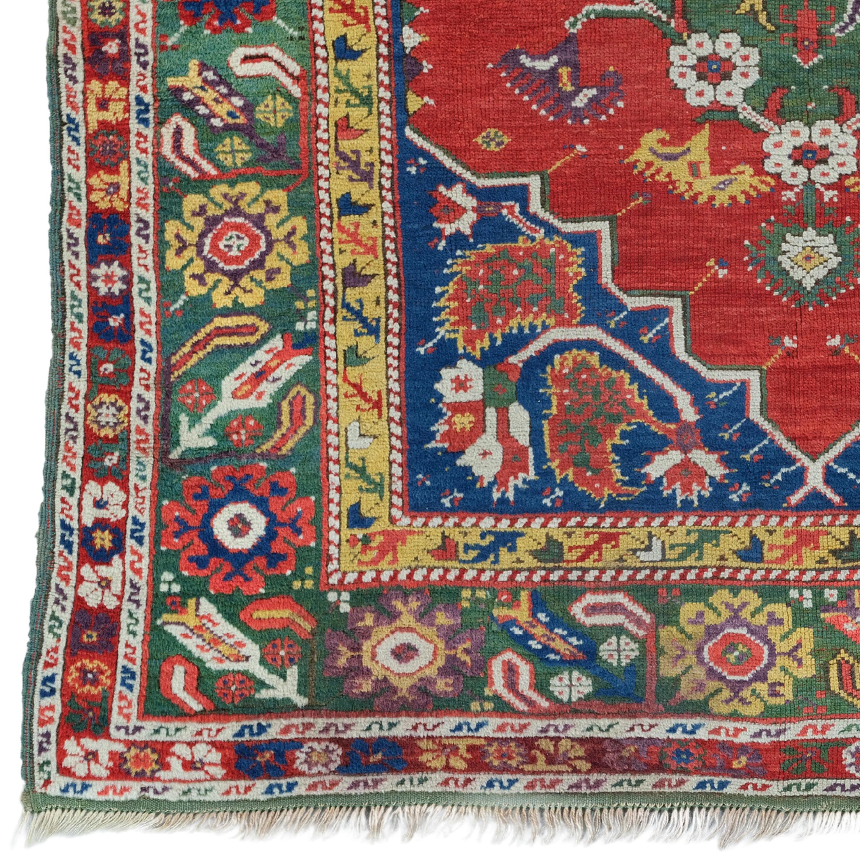 A Timeless Weaving Wonder This elegant 18th century antique Ushak carpet attracts attention with its rich color palette and intricate patterns. The central medallion and surrounding floral motifs reflect the high-quality weaving techniques typical