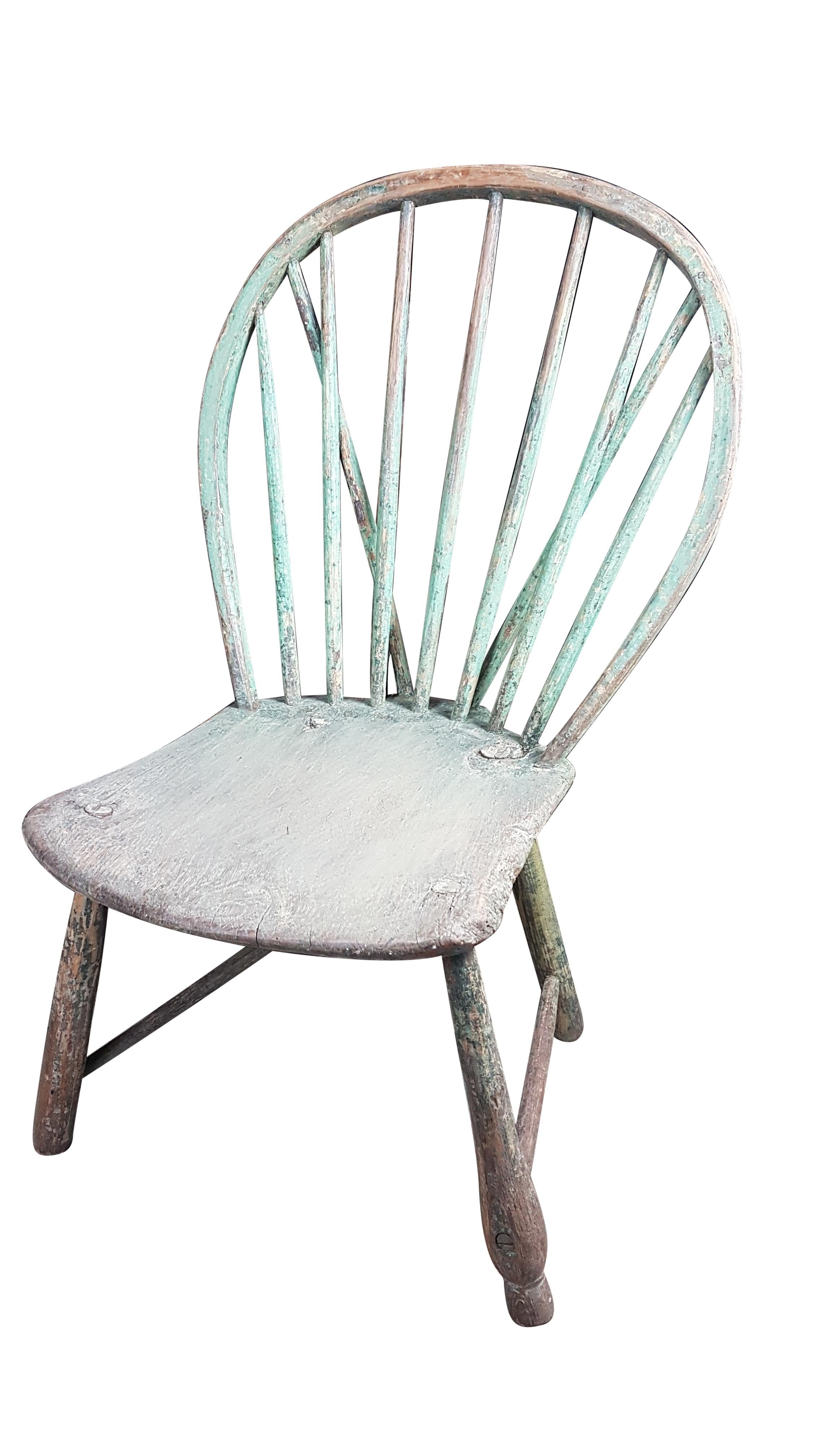 A beautiful rustic original 18th century West Country Yealmpton hoop back chair that has carefully been taken back to its original painted green finish which is very vibrant. It has three types of legs but all have the same original base paint color