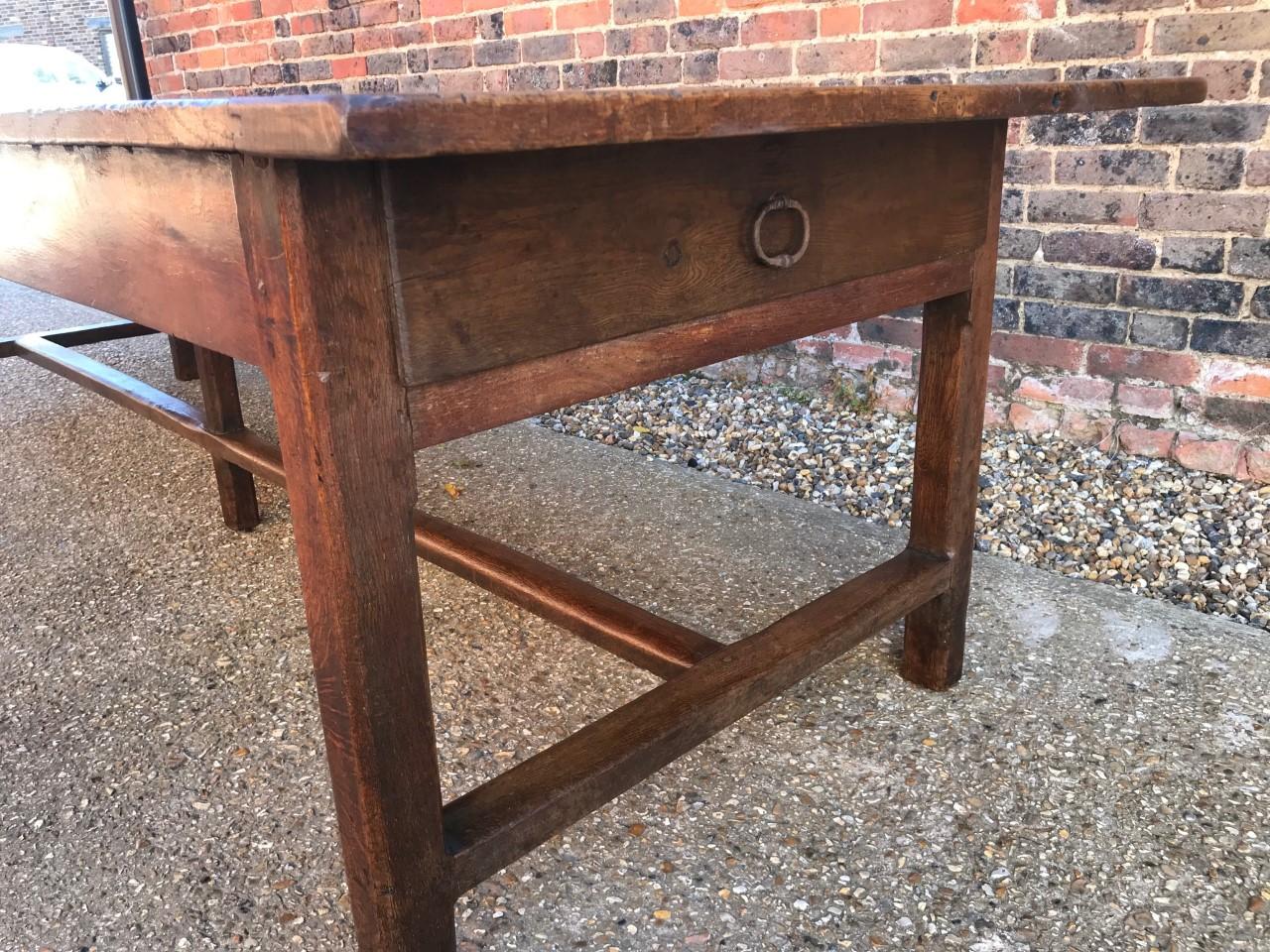 Rare large 18th century oak dining table with exceptional color and patination. This table has the most exquisite top and wonderful proportions. The width alone on this table is rare. The table stands on square end stretchers with a centre