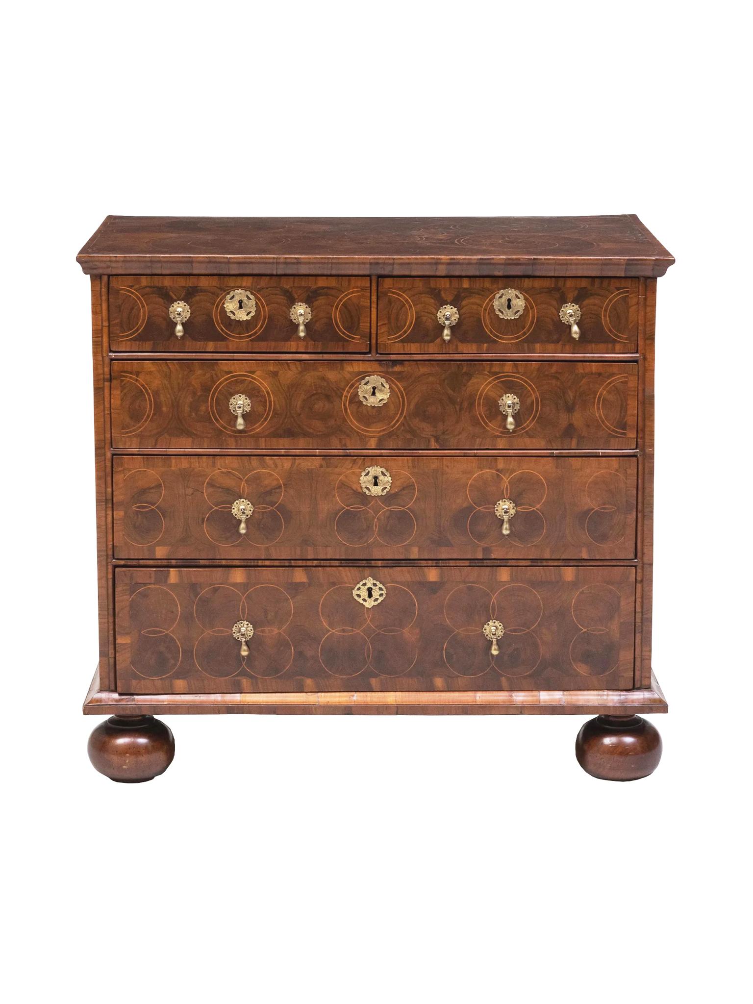This outstanding William & Mary chest of drawers has been well-cared for over the centuries. We love the exquisite veneer and oyster inlay that decorate the surfaces in intricate concentric and floral designs. The chest has had beautiful restoration