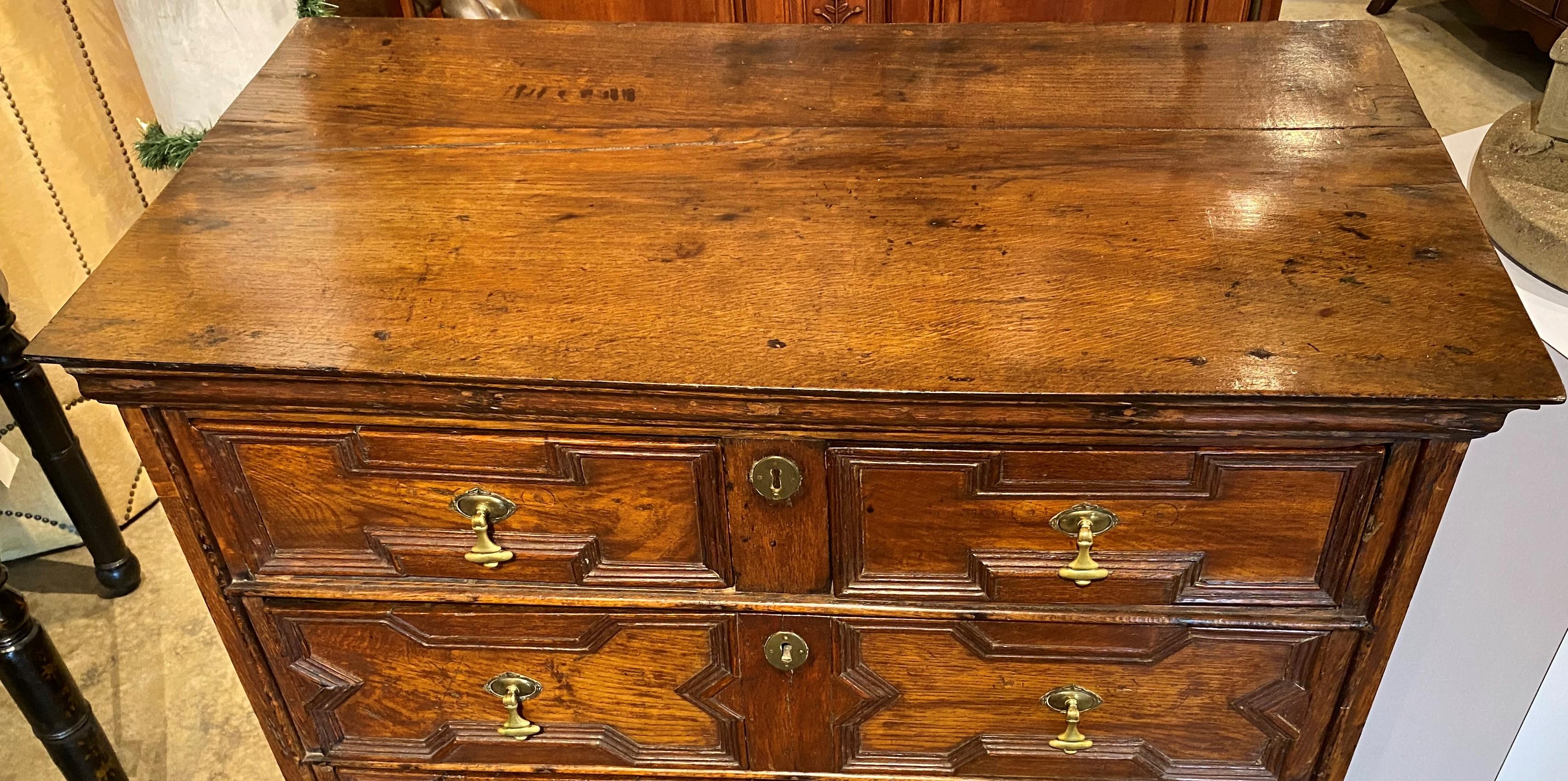 A fine William & Mary two-over-two rectangular chest on frame with molded drawer front decoration, each drawer with replaced period oval drop pulls, supported on a frame with four turned legs and stretcher base. English, dating to the 18th century,